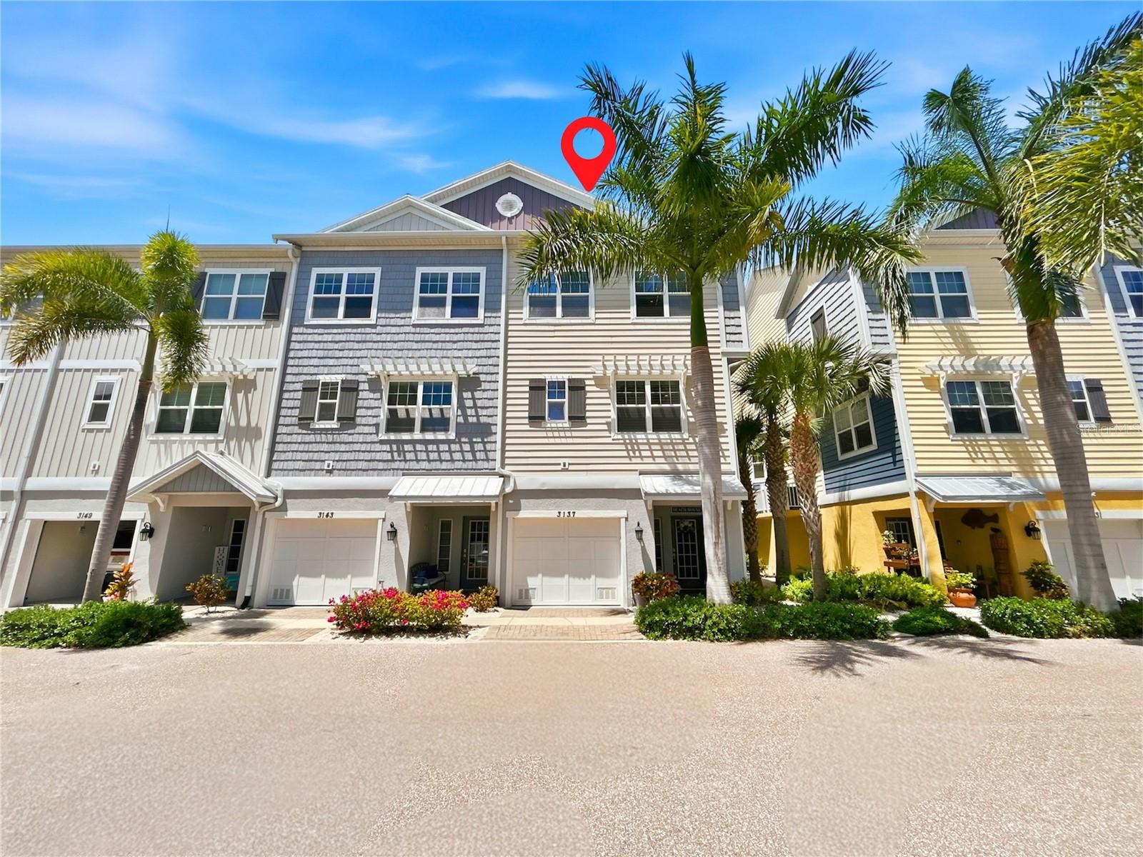 Welcome to paradise! Whether you’re a boating enthusiast or a nature lover, this prize, corner unit in the Key West-inspired, gated community of Cove at Loggerhead Marina offers it all.  With high ceilings, plantation shutters, upgraded porcelain tiles throughout and boasting a private elevator for convenience, this beautiful home exudes elegance and modern comfort. The oversized two-car, tandem garage with epoxy flooring, includes an understairs storage space and ample room for a workshop or gym. To the rear, an extended patio provides both privacy and space to entertain in a nature setting. The heart of the home is the gourmet kitchen with its granite counters, hard wood cabinets and closet pantry. The sheer attention to detail put into the design of this three-story townhome is very evident in the spacious living room, with the curve of its bay windows and architectural design features. Sliding glass doors lead to the generous screened balcony, which extends the width of the property. A perfect spot to enjoy the lush views of the adjoining six acre preserve, with its walking trail and native plantings. A ½ bath, large hall closet and flex room, which is currently being used as a separate dining room, make up the rest of the second floor. Above, you will find the primary suite with cozy seating area, ensuite and walk-in closet. The laundry is conveniently located next door, with two further bedrooms down the hall, one of which includes a queen-size murphy bed which will convey with the sale of the property. For those who like to indulge themselves, the second full bath includes a freestanding, air jetted bathtub and subdued lighting. The community encourages an active lifestyle and offers a saltwater pool, complete with covered tiki huts and BBQ areas, a Captain's Lounge with full kitchen and a full-service marina offering the Freedom Boat Club and the option for either wet or dry storage. With easy access to Boca Ciega Bay and the Gulf of Mexico, it is a boater's dream. All this and more, just ten minutes from downtown St. Pete’s and the local beaches.