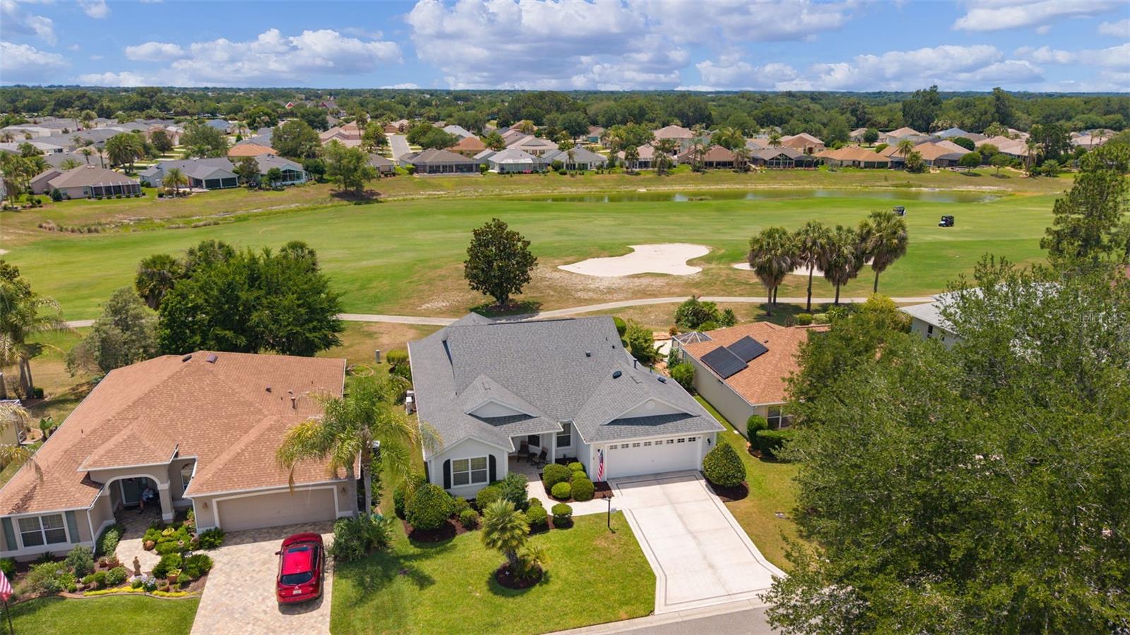 MOVE-IN READY Designer Golf Course Home in Prime Virginia Trace – Steps from Lake Sumter Landing!

Welcome to 1426 Honea Path, a beautifully maintained 3/2 Camellia (Gardenia) model in the highly sought-after Village of Virginia Trace. This expanded designer home sits directly on the 6th Hole of the Virginia - Mallory Country Club Championship Golf Course, delivering stunning golf course views from nearly every rear window. Enjoy peaceful fairway vistas, spectacular sunsets and wildlife — all from the comfort of your large air-conditioned Florida Room or the shaded pergola patio.

Located just a short walk or quick golf cart ride, only half mile to Lake Sumter Landing Market Square, this home offers the ultimate Villages lifestyle with dining, shopping, live entertainment, and waterfront activities right around the corner. Residents also enjoy quick access to the Canal  Street Recreation Center, community pool and postal station.

The home has been lovingly cared for with neutral paint throughout, knockdown ceilings, granite countertops, and newer stainless steel kitchen appliances. Other features include a spacious kitchen with pull-out cabinets and large pantry, volume ceilings, an open floor plan, wood plank laminate flooring in main living areas, tile in wet areas, and carpet in the primary bedroom.

The generous master suite features a large ensuite bath with dual sinks, granite counters, a walk-in shower, and dual walk-in closets, plus direct access to the Florida Room. Two guest bedrooms (one with a Murphy bed and built-in desk/cabinetry) provide flexibility. The expanded 2-car garage has ample space for 2 cars and golf cart parking as used by the current owners, a painted floor, workshop area, and solar attic fan.

Major value-adds include:
**Bond is fully PAID
**HVAC 2026, Smart Thermostat
**Roof replaced in 2020
**Water heater 2018.

Priced to reflect exceptional value for this golf course location and proximity to Lake Sumter Landing and all the amenities, this home is waiting for its next chapter. Don’t miss the opportunity to own a designer home in one of The Villages’ most convenient and desirable golf course neighborhoods.

Call us today to schedule your private showing!