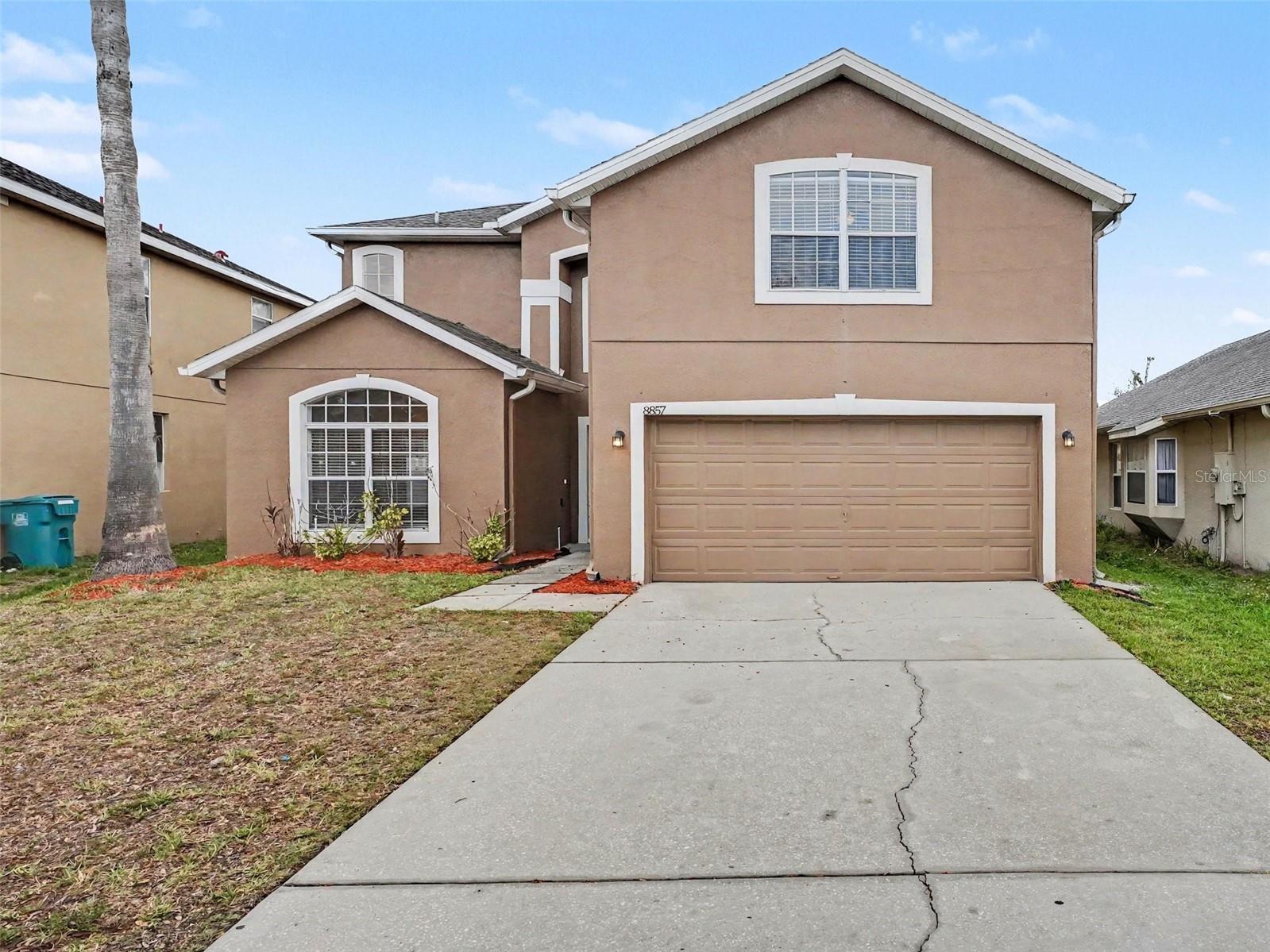 This 5-bedroom, 2.5-bathroom two-story home offers a spacious footprint and a fantastic equity-building opportunity for buyers looking to customize a property to their exact taste. As a home that needs some TLC, it features a traditional floor plan that begins with a formal living room situated at the front of the home, perfect for a quiet sitting area or reception space. The kitchen is designed for efficiency, equipped with practical formica countertops that await your personal modern updates. The second level is highly functional and smartly zoned, housing the primary bedroom suite, a dedicated laundry room, and a versatile flex space that can easily serve as a home office, playroom, or media lounge. Complete with an attached 2-car garage and a relaxing screened-back patio, this property provides an excellent structural foundation in a desirable multi-level layout.