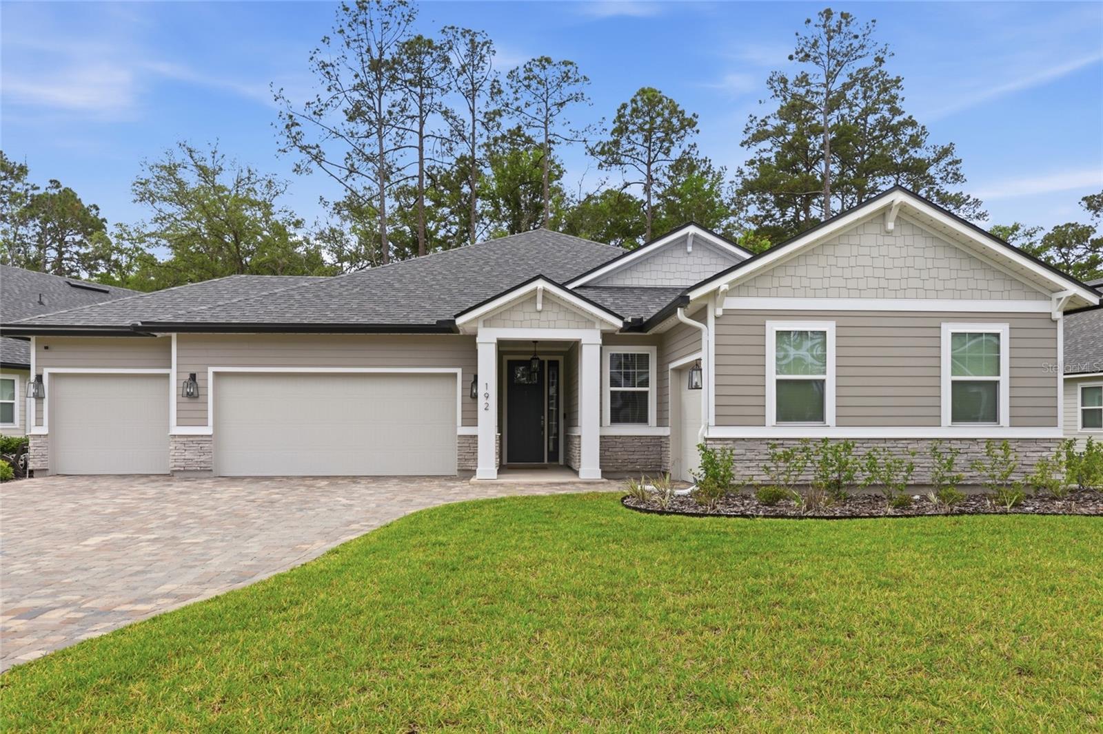 Welcome to 192 Goldenrod Drive, a beautifully appointed home in the highly sought-after TrailMark community offering the perfect blend of luxury, functionality, and Florida lifestyle. Situated on a preserve lot with peaceful views and added privacy, this thoughtfully designed home features an impressive 4-car garage configuration with a spacious 3-car garage on one side and a separate single-car garage on the other -- ideal for extra vehicles, storage, hobbies, or a home gym setup. Inside, you'll find stylish custom touches throughout including a stunning board and batten entryway and a designer feature wall in the office/flex room. The open-concept floor plan is enhanced by high ceilings, 8-foot doors, upgraded lighting and ceiling fans, and large sliding glass doors that lead to the covered lanai, seamlessly blending indoor and outdoor living. Luxury vinyl plank flooring flows throughout the main living areas, while the bedrooms offer comfortable carpeting.

The gourmet kitchen is designed to impress with quartz countertops, a beautiful backsplash, gas cooktop, double ovens, walk-in pantry, and ample prep space for entertaining. The spacious primary suite features a custom California Closet system, while the mudroom drop zone with built-ins and indoor laundry room add everyday convenience. Additional upgrades include a tankless water heater, water softener, security system, blinds throughout, washer and dryer, sprinkler system, paver driveway and walkway, wrought iron fencing, and permanent Gem exterior lighting with AI capability and customizable holiday lighting options.

Step outside to enjoy the covered lanai and extended paver patio -- the perfect spot for grilling, relaxing, or gathering around a firepit while overlooking the tranquil preserve.

Residents of TrailMark enjoy resort-style amenities including a beach-entry pool, fitness center, pickleball and basketball courts, playgrounds, dog park, kayak launch onto Six Mile Creek, scenic walking and biking trails, lakeside Camp House pavilion, and a vibrant calendar of community events and activities. Conveniently located near top-rated St. Johns County schools, shopping, dining, and easy access to I-95.