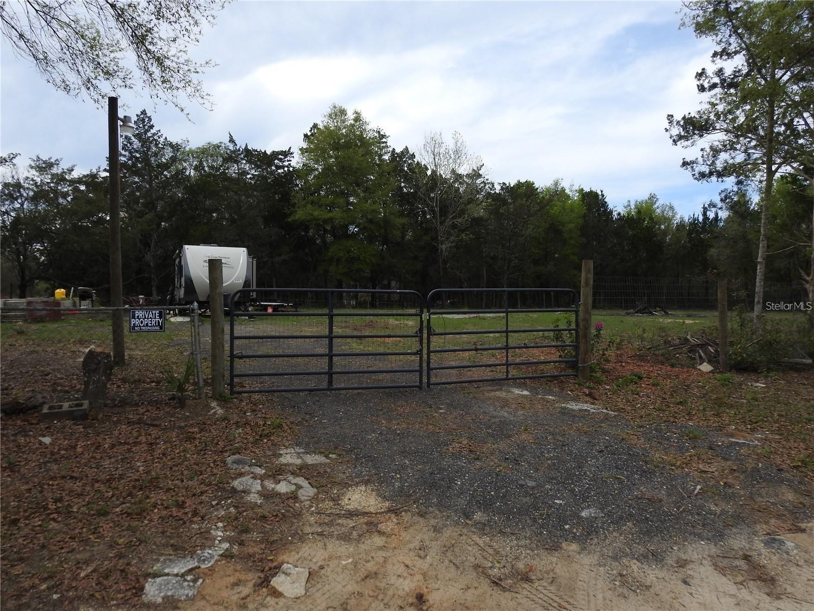 Seller will consider Owner financing with $10,000 down and interest at 6% for 15 yrs (negotiable). Ready to build Homesite/RV Pad in a quiet neighborhood. Well and septic is already in place, as well as a concrete foundation. Water is connected along with a new Pump and Pressure Tank installed 2023. Septic has been pumped and serviced 2023. Improved land with Boundary Fence installed along with new driveway 2023. Property has been cleared in the center, ready to build or place a mobile home. RV has been removed and does not convey with the land.