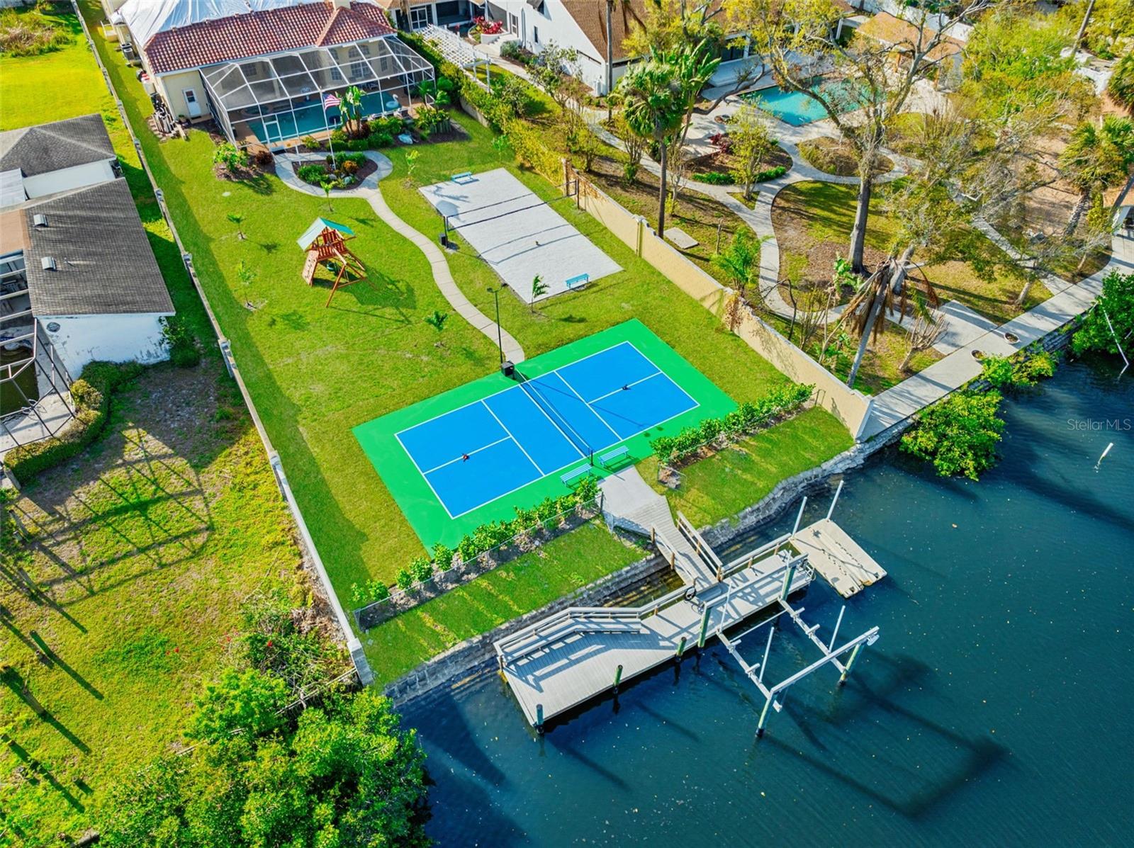 Experience the pinnacle of waterfront luxury in this extraordinary fully furnished estate, perfectly positioned on over half an acre with more than 80 feet of deep-water canal frontage and direct access to the open waters of Tampa Bay within minutes. From breathtaking sunrises to spectacular sunsets, this exceptional residence offers the ultimate Florida boating lifestyle with a private dock, 13,000-pound boat lift, and floating platform for personal watercraft.
Recently transformed with extensive high-end renovations, this impressive 5-bedroom, 4-bath residence spans 4,337 square feet and showcases all-new designer bathrooms, a stunning chef's kitchen, and premium furnishings throughout. Every detail has been thoughtfully curated, creating a truly turnkey opportunity where luxury, comfort, and sophistication seamlessly converge.
The newly upgraded gourmet kitchen serves as the heart of the home, featuring premium stainless-steel appliances, double wall ovens, expansive stone countertops, a breakfast bar, built-in coffee station, butler's pantry, custom cabinetry, soft-close drawers, and abundant storage. The adjoining family room is equally impressive, highlighted by a gas fireplace, custom mantel, surround sound system, and expansive windows overlooking the resort-style pool and waterfront setting.
The luxurious primary suite provides a private retreat with soaring ceilings, oversized windows, dual walk-in closets, and generous accommodations for large-scale furnishings. The spa-inspired primary bath has been beautifully updated, offering a relaxing sanctuary with premium finishes and designer details.
Additional guest accommodations are thoughtfully arranged, including a private guest suite with its own ensuite bath and walk-in closet, while the remaining bedrooms offer spacious layouts and exceptional comfort for family and visitors alike.
A spectacular second-floor bonus room spanning over 1,000 square feet creates the ultimate entertainment destination. Complete with a custom granite wet bar, beverage center, impact windows, and private bath, this versatile space is perfect as a media room, game room, executive lounge, or luxury retreat.
Outdoor living reaches new heights with a screened saltwater pool and spa, featuring an impressive swim-up bar and expansive entertaining areas. Beyond the pool, the sprawling backyard leads to your private waterfront oasis, where boating, fishing, paddleboarding, and sunset cruises await just steps from your door.
For active lifestyles, the property also features a private tennis and pickleball court, creating a rare resort-style amenity package seldom found in waterfront homes.
Additional features include an oversized three-car garage with workshop space, custom mudroom, laundry room with cabinetry and utility sink, security system, custom landscape lighting, irrigation system, multiple water heaters, covered lanai, and lush tropical landscaping.
Offered fully furnished with all new designer furnishings included, this exceptional estate is truly move-in ready. Located within one of the area's most desirable waterfront communities, residents enjoy convenient access to premier golf courses, fine dining, upscale shopping, top-rated public and private schools, Downtown Tampa, Tampa International Airport, and the award-winning Gulf beaches.
A rare opportunity to acquire a fully renovated, fully furnished luxury waterfront estate where every detail has been completed to perfection!