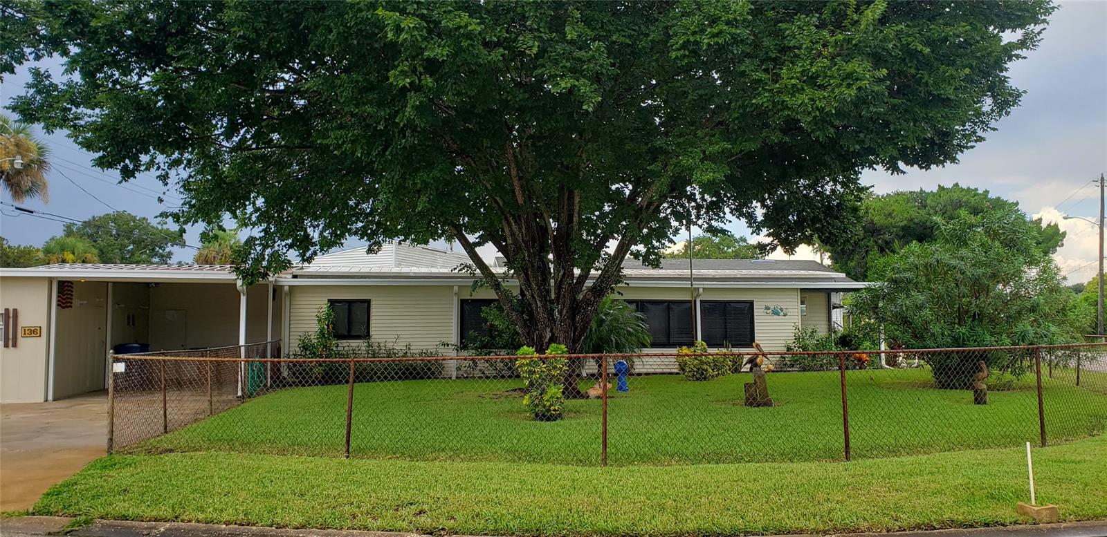Come and enjoy the quaint charm of this hidden gem located in a riverfront fishing village.  This 2 bedroom 1.5 bath is situated on a corner lot 2 blocks from the river.  This golf cart community offers 350' of fishing pier, boat launch, community club house, community BBQ grill, 2 saltwater swimming pools, boccie ball court, shuffleboard court, basketball, on site laundry facilities and is a family park.  Low amenity fees of $125.00 per month.  This home boast a 51.3 front addition that complements the original home.
The well manicured corner fenced in lot offers a variety of plants and shrubs as well as a beautiful shade tree situated on an oversize lot. ;Water: City