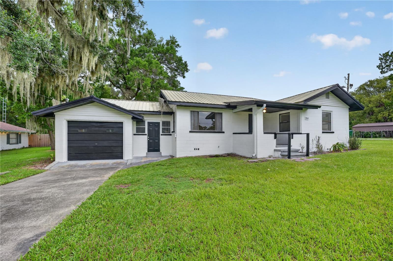 Sitting on just over an acre in the heart of Belleview, this 2-bedroom, 1-bath residence brings plenty of flexibility to the table. The main home has been refreshed with new flooring, fresh interior paint and updated appliances. Out back, the detached ADU-style building offers its own electric, toilet, sink, bay garage door, and metal roof—ideal for a workshop, studio, office, storage, or a number of other possibilities. Add in B-2 Community Business zoning, and this property opens the door to residential, professional, retail, service-oriented, or mixed-use potential, subject to city approval. With multiple structures, plenty of usable space, and quick access to CR 484, US 441/301, shopping, dining, and everything Belleview has to offer, this is one of those properties that can work in more ways than one.