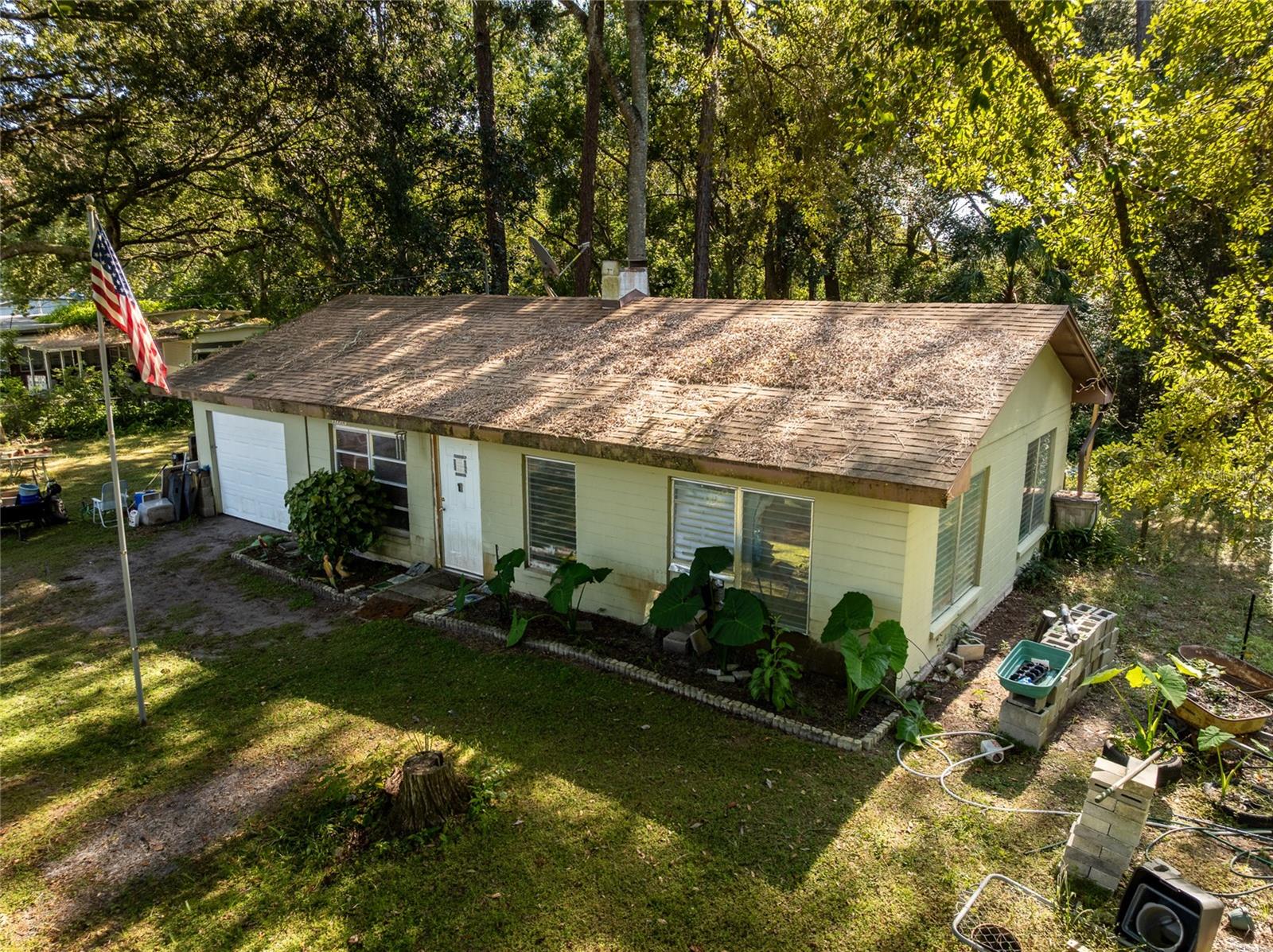 SELLER SAYS SELL!!***Country living on over half an acre—with room to breathe, roam, and truly unwind! This cabin-style concrete-block home sits tucked at the end of a quiet street, right beside a small creek, giving you that peaceful “away from it all” feeling while still being close to everything. Surrounded by nature and backed by your own private slice of forest, this property offers plenty of space for an RV, trailer, boat, or extra vehicles—and yes, there’s room for animals too.

Step onto the property and you’ll immediately feel the charm of country life: towering trees, birdsong in the morning, and wide-open skies perfect for stargazing at night. With no HOA, you’re free to create the lifestyle you’ve always dreamed of.

A survey is available for your review.

Inside, the home offers solid bones and a warm, rustic feel—complete with a brick wood-burning fireplace, adding cozy cabin vibes on cool Florida evenings. It’s an ideal canvas for anyone with a creative vision. Whether you're a first-time home buyer, downsizing, or an investor seeking a value-add opportunity, this property has the space and potential to truly shine with updates and personal touches.

Location perks:
• Minutes to the Ocala National Forest, where you can hike, fish, camp, swim, and explore Florida’s natural beauty.
• Only 15 miles to award-winning Historic Downtown DeLand, full of restaurants, shops, festivals, and Stetson University.
• Nearby Umatilla parks and Lake Eustis for boating and water sports.
• About 50 minutes to New Smyrna Beach and within easy access to I-4 for Orlando’s theme parks and attractions.
• Close to Clearwater Lake and the St. Johns River—perfect for picnicking, canoeing, boating, or casting a line.

This is your chance to own a peaceful slice of country paradise at an affordable price. Bring your dreams, your projects, your toys—and fall in love with the tranquility this home offers.

Schedule a viewing today and imagine the country lifestyle waiting for you! Please note that all information and measurements are intended to be accurate but are not guaranteed. Buyers and their agents should verify all property details, including zoning, schools, HOA rules, pet restrictions, and potential uses.