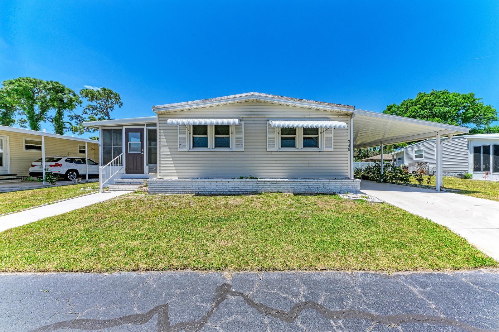 Perfect Home for a SNOW BIRD  OR  A "YEAR-ROUNDER "!!   The Arbors is  the BEST of the Florida sun belt communities.   THE ROOF -- New in 2022 with 15-Year Transferable Waranty.   THE CARPORT --  New 2023  No leaks.  This lovingly maintained manufactured home is in a PET FRIENDLY zone.  Your LOW $215/month HOA provides:  YOUR Water.  YOUR Sewer.  YOUR Lawn care.  YOUR Cable service.  A lucky buyer could move in right away and make some upgrades as needed.  YOU and your fellow homeowners will own the company that owns the park. it's a Co-Op park  for over-55 owner residents.  Therefore, everybody takes pride in keeping it wonderfully maintained and reasonably priced with low HOA dues.  Better take a look before  the bidding war starts.