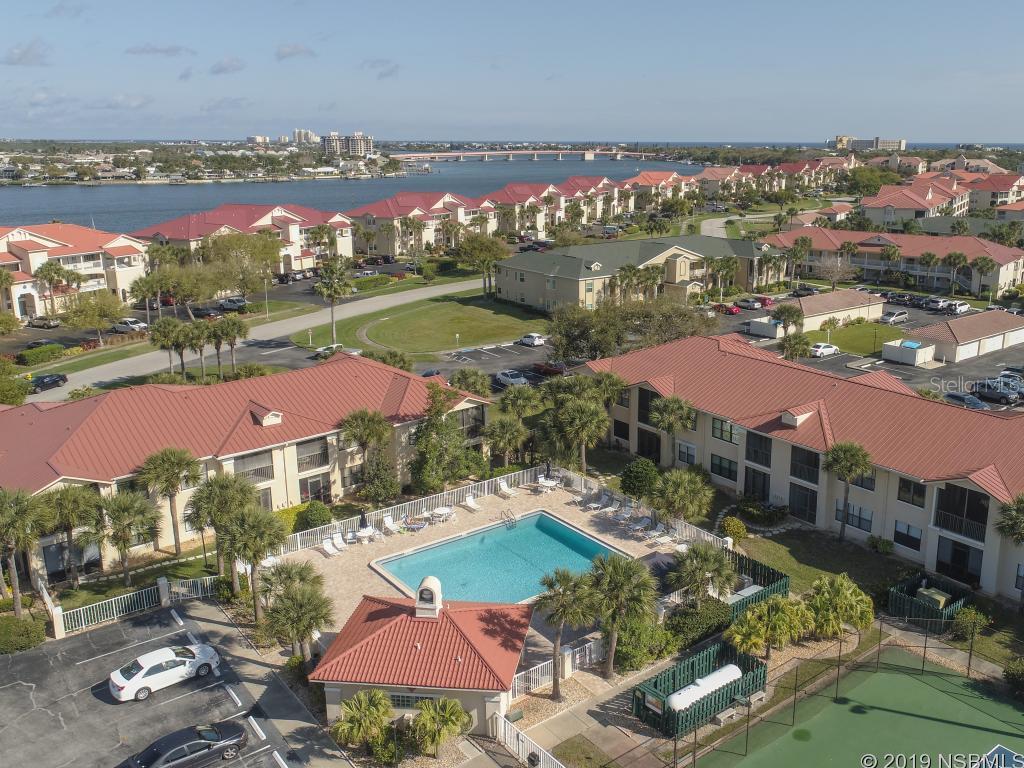 Perfectly maintained and well cared for 2 bedroom 2 bath unit with a GARAGE RIGHT OUT OF YOUR FRONT DOOR all within the wonderful waterfront community of Bouchelle Island! Dry boat storage, wet slips with boat ramp, tiki bar, pools, tennis, fitness center, 18 hole chip and putt, riverfront board walk and amazing breezes coming off the water make this active community one of the most desirable in New Smyrna beach! Bike to Flagler Ave and all the shops, entertainment, and resturants. Upgraded tile throughout and a split bedroom floor plan round out this wonderful choice for beachside living. Make the choice today to come and live the dream! ;Water: City