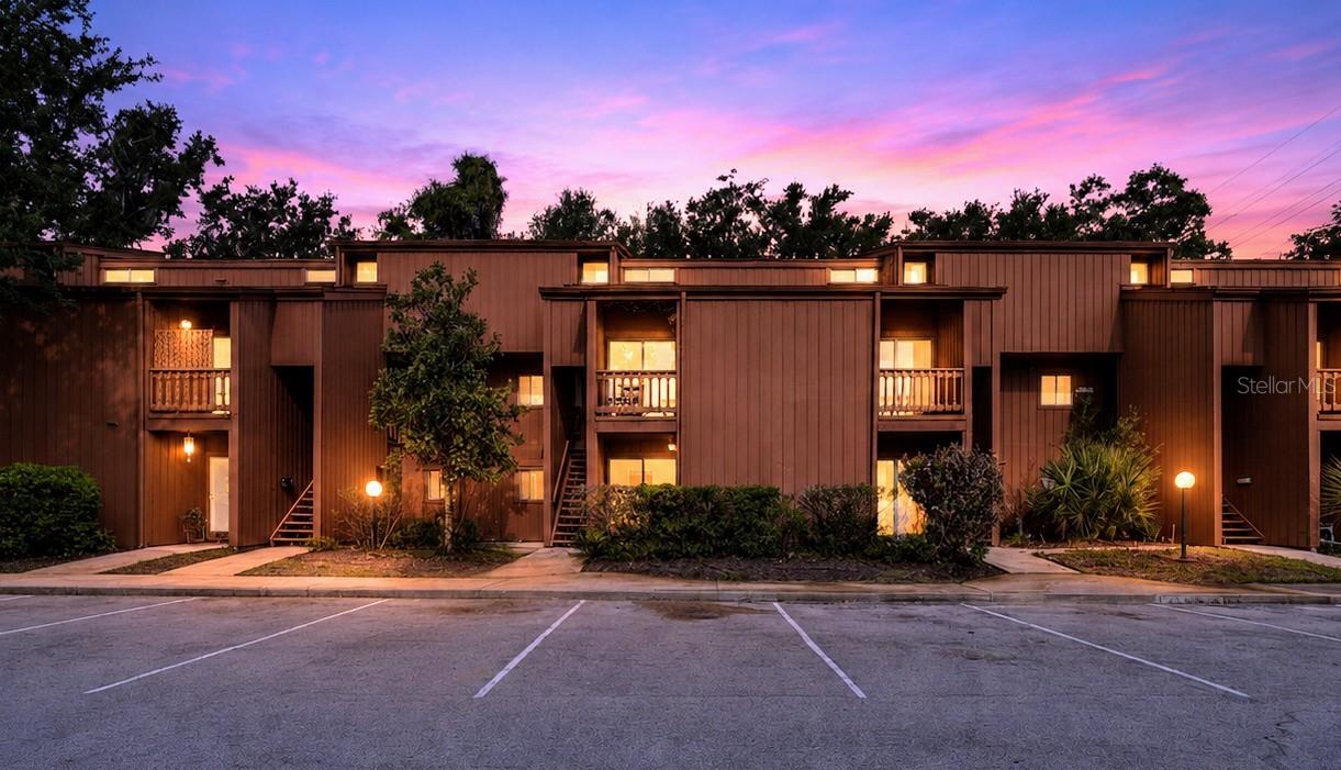 Tucked beneath the grand canopy of trees in the gated community of One Thousand Oaks, this oversized FIRST-FLOOR 1-Bedroom offers a sense of space and serenity rarely found at this price point. Wall-spanning sliding glass doors flood the open living and dining rooms with natural light and create an airy, atrium-like connection to the outdoors.  Two private patios offer additional outdoor living space. CROWN MOLDING and FULL TILE FLOORS run throughout, but storage is where this condo truly stands apart.  Just inside the front door, a spacious walk-in closet greets you — ideal for luggage, keepsakes or an at-home pantry.  The KING-SIZED bedroom is served by an additional generous walk-in closet that boasts BUILT-IN SHELVING, giving this condo the kind of storage most buyers only find in much larger homes. Thoughtfully renovated including a brand-NEW A/C and HOT WATER HEATER, Updated Electrical, fresh Professional INTERIOR PAINT, and refinished ceilings--meaning all of the big-ticket items are already handled. The kitchen features NEW Stainless Appliances and IN-UNIT Laundry Hookups.  An INCLUDED CARPORT with Overhead Attic Storage rounds out the practical wins.  One Thousand Oaks delivers resort-style living: a large Swimming Pool, Tennis Courts, and a Spacious Clubhouse you can reserve for gatherings. The HOA covers water, sewer, trash, pest control, roof, grounds, and all exterior maintenance — so your weekends stay yours.  And the location is hard to beat. In the heart of SODO, you are minutes from downtown, the hospital district, dining, shopping, major highways, and Orlando International Airport.  Whether you are an owner-occupant or an investor, this is a rare, move-in-ready find in one of Orlando's most central and desirable locations.  Come see this gem today!