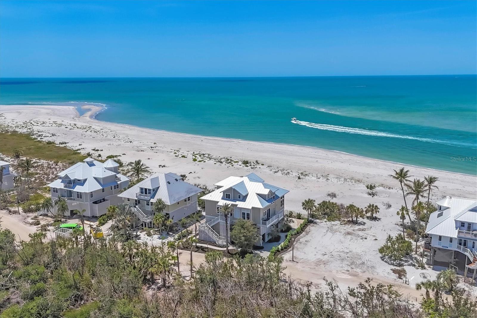 Beachfront Paradise on Palm Island – Unmatched Coastal Luxury!
Experience the ultimate in island living with this exceptional beachfront home located within the exclusive Palm Island Resort, offering stunning panoramic views of Stump Pass, Boca Grande and unforgettable sunsets over the Gulf of Mexico (America). Thoughtfully designed with quality construction by Southern Design Home Builders and attention to detail throughout, this coastal retreat blends timeless elegance with casual comfort.
Currently configured as a 3-bedroom, 3-bath home that sleeps ten comfortably, it has a library/office easily convertible to a 4th bedroom. The third bedroom is configured as a kids' bunk room. The open and airy floor plan is designed for relaxed entertaining. The spacious, screened lanai with a lower outside deck invites you to experience refreshing coastal breezes and the soothing sound of the waves, while the stunning great room with a soaring 25-foot ceiling—adorned with walls of windows and anchored by a cozy fireplace—offers warmth and charm on cooler evenings.
The chef’s kitchen, equipped with plenty of counter space, a large 5-burner cooktop, double ovens, refrigerator and wine cooler, is perfect for hosting family and friends in the adjoining dining area with its views of the beach. The adjacent butler's pantry/laundry room with utility sink, additional full-size refrigerator and work desk is a great complement to the kitchen. The upstairs master suite is a true private retreat featuring a private sundeck, luxurious computerized step-in shower, large walk-in closet, beverage cooler, and a wall of windows framing endless Gulf views.
Additional highlights include: automatic, battery-operated shades for ease and comfort, a three-stop elevator for convenient access, 10 ft ceilings throughout, 22 KW generator for added peace of mind, a shed with a massive storage area for all your island toys, two finished attic areas, and a new metal roof, newer AC units, a newer tankless hot water heater and a fully built-out deck below the home which allows for you to enjoy the outdoors regardless of weather. You’ll also appreciate the large outdoor shower for after a day spent at the beach!
Enjoy quiet walks (often not seeing another beachgoer for miles) along the 7 miles of pristine, sandy beaches, collecting shells and sharks' teeth, or simply relax and embrace the laid-back lifestyle that Palm Island is known for.
Palm Island Resort amenities include bell service, Rum Bay Restaurant, pool and spa, security, tennis and pickleball courts, playground, dockage and more. Access to the island is easy via a quick car ferry ride, after which you’ll experience golf-cart-only transportation throughout the resort, ensuring a truly serene and relaxed island atmosphere.