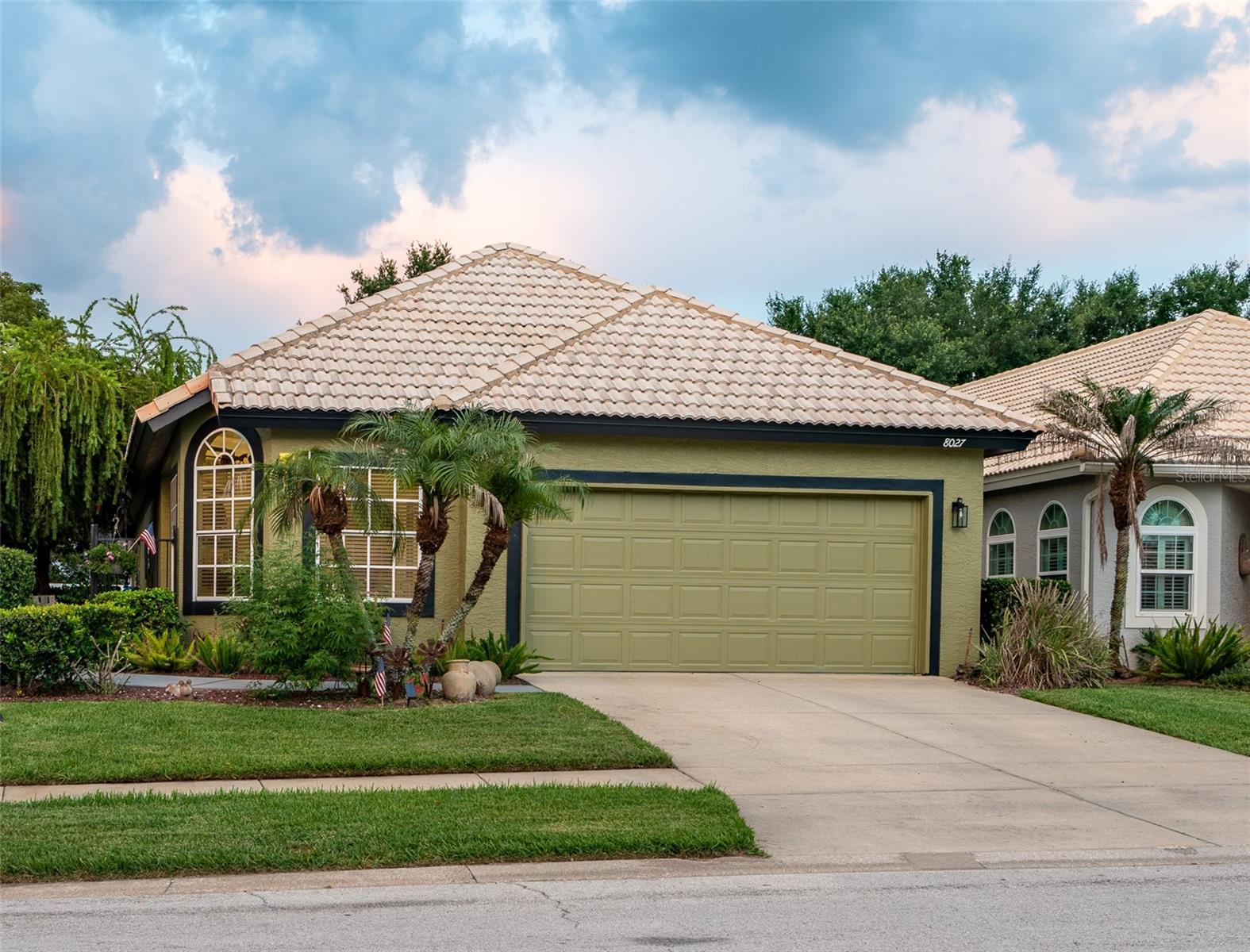 Nestled in the peaceful St. Andrews community within the Country Club of Mount Dora, this beautifully updated home with a Mediterranean-style tile roof offers exceptional value, thoughtful design and an inviting lifestyle.
A private courtyard entrance surrounded by lush landscaping provides the perfect setting for morning coffee or an evening glass of wine. Inside, the flexible two-bedroom, two-bath floor plan includes a bonus nook off the living room—ideal for card games, reading or relaxing—as well as a separate office/den that could be used as a third bedroom.
Recent upgrades include a beautifully remodeled primary bathroom and new Café appliances, adding both style and functionality. The light and bright kitchen features glass-block backsplash accents, updated solid-wood cabinet and drawer fronts, decorative hardware, generous storage and additional buffet cabinetry with granite countertops and upper cabinets for serving and display space.
Wood-look luxury vinyl flooring flows throughout the home, while the open-concept design and high ceilings create a spacious, airy feel. Plantation shutters and custom window treatments provide privacy while allowing you to control the natural light.
The fully screened rear porch has been extended across the entire back of the home, creating an approximately 10-by-30-foot outdoor living area with plenty of room for grilling, entertaining and even a spa. The backyard is enclosed with low-maintenance vinyl fencing, offering privacy and space for pets.
The St. Andrews community pool, clubhouse and exercise room are located just steps away and serve residents of St. Andrews and St. Ives. Access to these amenities is included in the community HOA fee. The air-conditioning system was replaced in August 2022.
The Country Club of Mount Dora offers a beautiful clubhouse with a restaurant and bar open to the public, along with golf, pickleball, social events, dining opportunities, meeting rooms and additional amenities available through membership.
Located just minutes from historic downtown Mount Dora, residents can enjoy shops, restaurants, art galleries, festivals and waterfront recreation. Stroll along winding sidewalks, enjoy the natural surroundings and follow the lakefront path to the boardwalk, marina and park.
The home also offers convenient access to Orlando and Sanford international airports, Central Florida attractions and both the Atlantic and Gulf coasts. Don’t miss the opportunity to own this beautifully updated home in one of Mount Dora’s most welcoming and convenient communities.