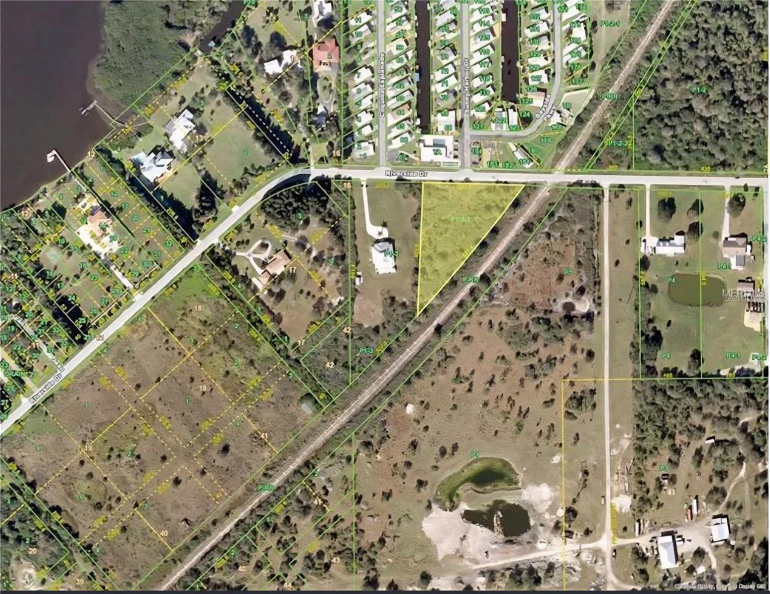 Exceptional 1.57-Acre Lot with 359 Feet of Frontage – Across from the Peace River/ Pelican Harbor

Discover a rare opportunity to own a spacious 1.57-acre level lot offering an impressive 359 feet of road frontage along Riverside Drive in Punta Gorda. Perfectly positioned directly across the street from the Peace River, this property delivers peaceful river views and easy access to the water lifestyle without the waterfront price tag.

Enjoy the best of both worlds, the tranquility of the river right across the road and the convenience of a public boat ramp just down the street. Nature and garden enthusiasts will love being in close proximity to the beautiful Peace River Botanical & Sculpture Gardens. Whether you’re planning to build a custom estate home, create a private retreat, or invest in land with strong potential, this parcel offers incredible flexibility.

Zoned RE1 (Residential Estate), this generous lot provides plenty of room to design the home and outdoor space you’ve been dreaming of. With substantial road frontage and a prime location in one of Punta Gorda’s most desirable corridors, this is a standout opportunity for buyers seeking space, privacy, and lifestyle.

Bring your builder opportunities like this with this much frontage and river proximity are hard to find.