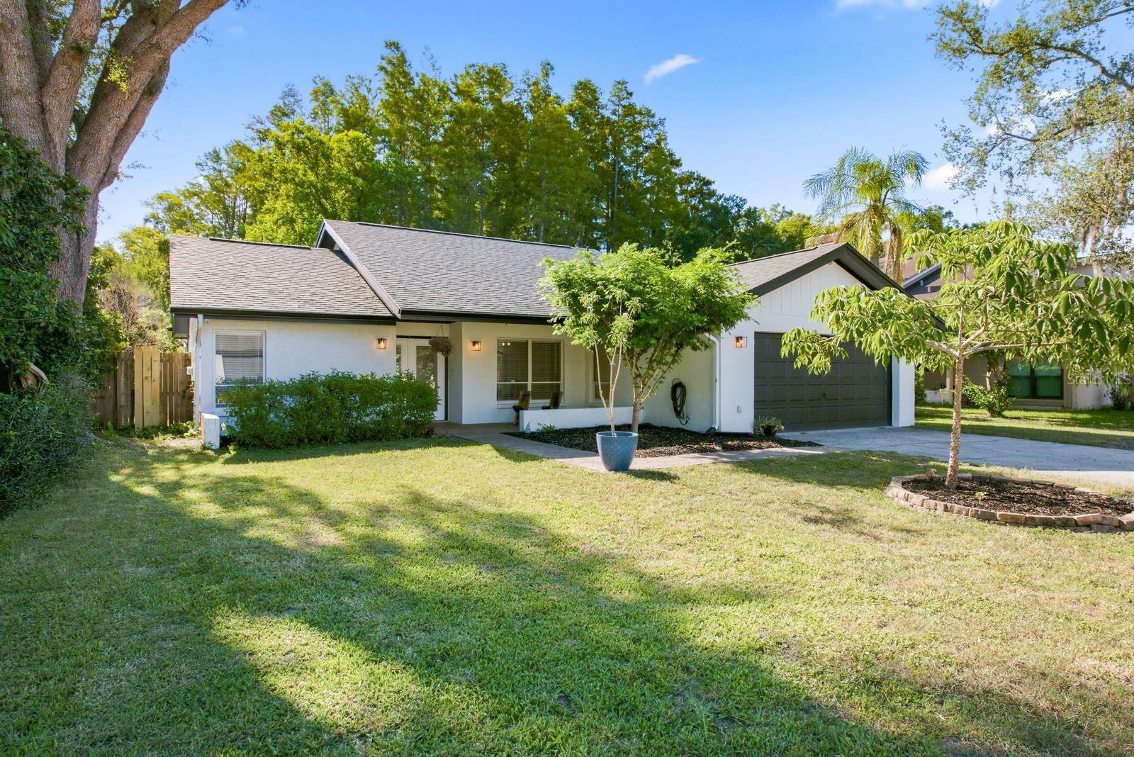 Nestled on a quiet cul-de-sac with beautiful curb appeal, this exceptional home offers private pond frontage with a serene conservation backdrop and an abundance of privacy. A brick paver entry welcomes you inside to a desirable split-bedroom floor plan featuring four bedrooms and two full-size bathrooms. The secondary bedroom is oversized and the spacious primary suite with French doors open to the gorgeous custom deck overlooking the pond and expansive backyard. The updated primary bathroom has been tastefully renovated, while the double-sided wood-burning fireplace creates warmth and charm between the living spaces. A versatile flex area located between the kitchen and primary bedroom provides the perfect space for a home office or playroom. Upgraded Low-E sliding glass doors maximize the stunning pond and conservation views and fill the home with natural light. The spacious kitchen is beautifully appointed with granite countertops and backsplash featuring beveled edges and rich wood cabinetry. Solar tube lighting enhances both the primary bedroom and oversized secondary bedroom. The newer custom deck (2026) is the ideal place to relax and enjoy the peaceful natural surroundings. Additional updates include an HVAC system installed in 2018, a hot water heater replaced in 2015, and both the main roof and flat roof replaced in 2026. All of this is complemented by exceptionally low HOA fees of just $200 per year. Ideally located, this home places you just moments from everyday conveniences and local favorites, including multiple grocery stores, breweries, restaurants, less than 20 minutes from Downtown Tampa, International Plaza & Bay Street, Tampa International Airport, and an array of top-rated dining and entertainment destinations, this exceptional property offers the perfect blend of comfort, convenience, and location. Don't miss the opportunity to make this Carrollwood gem your very own.