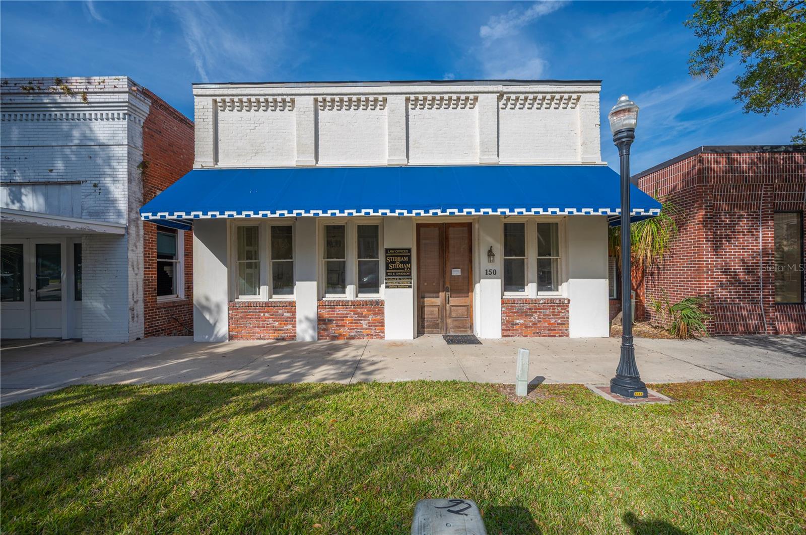Welcome to 150 Davidson St Bartow ,Fla...,Location is paramount with regard to this Historic Office building. Situated in a high visibility area , right across the street from both the new Bartow Courthouse and the Historic Courthouse. Built in 1911 By T.L Wilson & C.C Wilson two of Bartow's most prominent lawyers at the time as their primary office . This historical building has retained much of its original charm...  hard wood flooring covers most of the 2997 sq feet of office space. Along with retaining many of the original interior features... tall base boards, picture rail, built-in book cases & soaring ceilings this large space boasts 7 generous offices, extra large conference room, 3 bathrooms, kitchen, copy room along with approximately 12 parking spaces. Centrally located close to Historic downtown Bartow, and with-in walking distance to great restaurants, this one of a kind distinctive commercial opportunity is rare. Its size and functionality make it perfectly suited for a variety of uses with unmatched versatility in one Bartow's most desirable locations. There is a feature sheet with all room dimensions & extra property details in the attachments  of the listing.