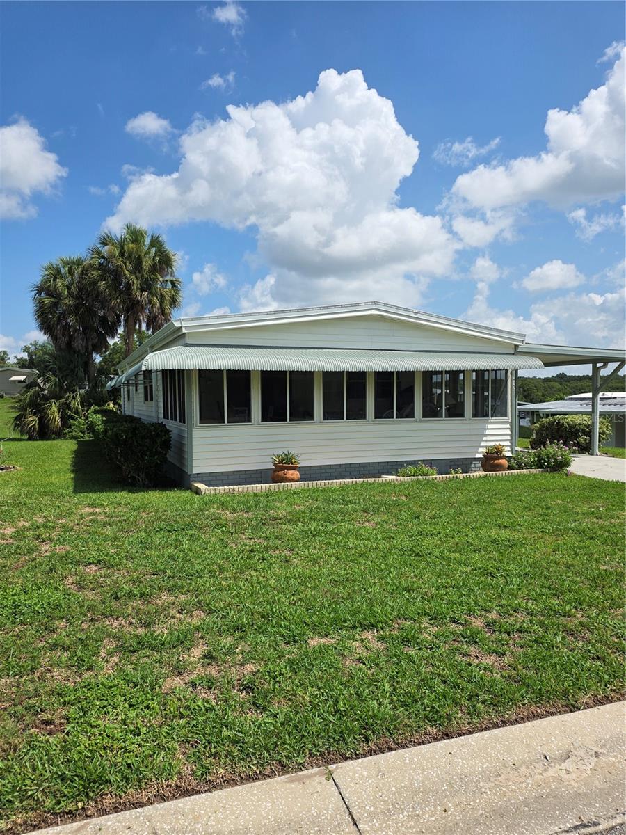 This beautiful 2 bedroom 2 bath home is waiting on your personal touches. Priced to allow you room for some upgrades and READY FOR QUICK CLOSE. All the MAJOR items have been taken care of: 2025 New A/C, 2025 New Membrane Roof, 2021 New Windows, Updated Kitchen and Bathrooms refreshed.  LOW PROFILE ENTRY STEPS. Extra large 22x9 Florida Room is perfect for entertaining or just relaxing on lazy afternoons. High Speed Fiber Optic Cable & Internet, Lawn care, Trash pick-up, 24/7 Manned Security Guards, On-site Park Management, 4 Pools, Woodshop, Greenhouse, Library, Craft Rooms, Pickleball, Line Dancing, Water Aerobics, Full Service Restaurant & Bar, Fishing Dock, Walking Trails, Fitness Center, just to name a few of the Amenities of our Premier 55 Plus Resident Owned Community nestled among the trees and rolling hills just North of Apopka a few miles South of Beautiful Mount Dora and still in Orange County.  You MUST COME SEE "Where The Good Life Begins". Call today to schedule viewing.  Close to shopping, hospitals, worship, airports, cruise lines and beaches.