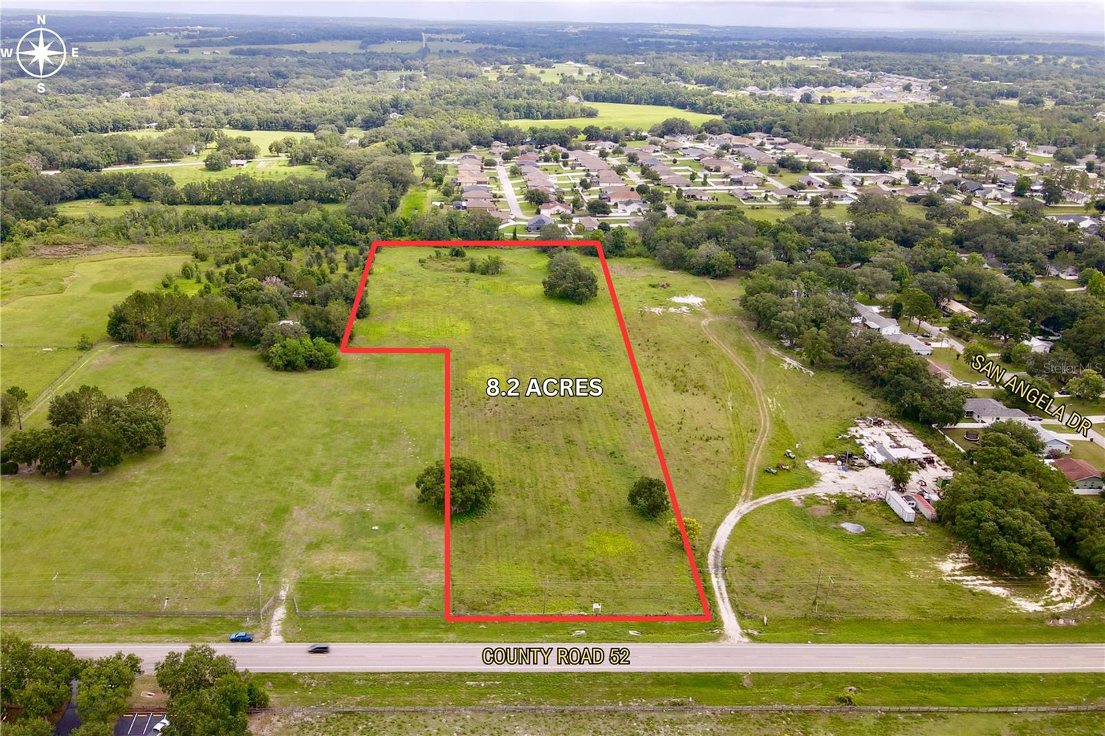 The opportunity is to purchase 8.2 acres of commercial land on County Road 52 in Pasco County. It has 210 feet of frontage on the highway and is located within the city of San Antonio.

The property was rezoned to PUD within the City of San Antonio. This allows for a wide range of commercial uses and entitlements are in place for future development. The PUD allows for all C-2 (General Commercial) zoning uses, and includes a 200 foot setback at the rear of the property. Examples of permitted uses include but are not limited to: selfstorage, retail, medical, contractor's office and storage, restaurants, hotel, building supply, and machinery repair.

Seller is open to a JV structure.

The property is located on the north side of County Road 52 in San Antonio in Pasco County. The parcel sits between Mirada Boulevard and Curley Street. Mirada is a 0.5 miles away, Saint Leo University is 1.6 miles away, and Lake Jovita is 1.5 miles away. Local shops, restaurants, and medical are located within half of a mile.

There is rapid growth occurring near the property, with projects including Double Branch, Mirada, Abbey Crossings, Leo at Cypress Creek, Q Terra, Villas at Connected City, and DHIC Mirada combining for more than 11,000 homes planned or under construction. Additionally, there’s a new Advent Health Hospital and Publix just down the road, as well as (planned) Amazon and Target 1M+ SF distribution centers.