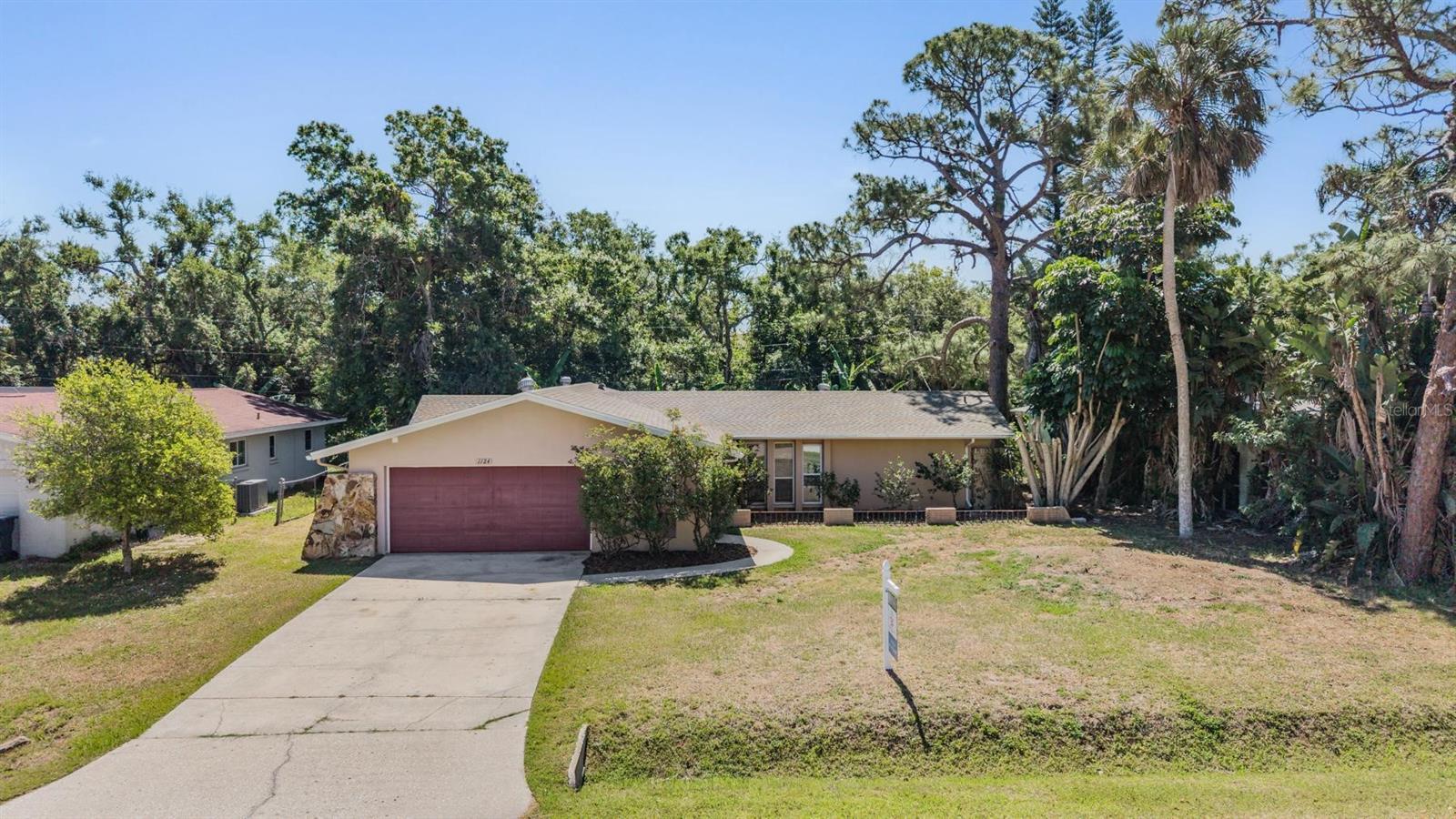 Charming Sarasota home offering a bright, open layout and great indoor-outdoor living! This well-maintained property features spacious living and dining areas with durable tile flooring throughout, creating a seamless and low-maintenance living space filled with natural light.

The updated kitchen showcases granite countertops, modern cabinetry, stainless steel appliances, and a convenient pass-through/breakfast bar—perfect for everyday living and entertaining. Multiple living areas provide flexibility for a family room, dining space, or home office setup.

Step outside to a large screened-in lanai, ideal for relaxing or hosting guests while enjoying the private backyard setting with lush greenery. The yard offers plenty of space to personalize and make your own outdoor retreat.

Additional highlights include a 2-car garage, generous driveway, and a functional layout with comfortable bedroom spaces. Conveniently located in Sarasota near shopping, dining, and major roadways, this home offers both comfort and accessibility.

Great opportunity to own a versatile home in a desirable Sarasota location—schedule your showing today!