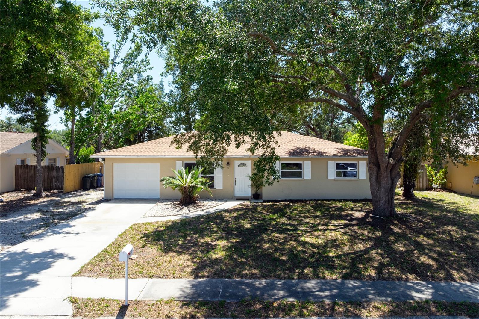 Tucked away on a quiet street in a convenient central Sarasota location, this beautifully updated home offers the perfect combination of comfort and freedom with NO CDD or HOA fees. You’ll appreciate the mature trees, fresh exterior paint, and extra side parking pad with plenty of room for an RV, boat, or additional vehicles. Inside, the home has also been freshly painted and features tile flooring throughout. The brand new kitchen is a standout with gorgeous quartz countertops, newer stainless steel appliances, and a clean modern design perfect for everyday living and entertaining. Both bathrooms have also been tastefully updated, while the brand new water heater and 3-year-old roof add peace of mind for years to come. One of the most unique features of this home is the large screened-in lanai under roof — not an aluminum add-on — offering the potential to easily convert it into additional living space or a spacious family room. Step outside to enjoy the fenced backyard with mature landscaping and a backyard storage/work shed perfect for hobbies, tools, or extra storage. If you’ve been searching for a move-in ready Sarasota home with upgrades already done, room for your toys, and no extra fees, this one deserves a closer look.