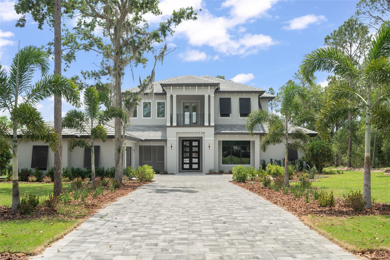 Experience the pinnacle of luxury in this exquisitely crafted home, showcasing an array of premium features throughout. The gourmet kitchen is a culinary masterpiece, equipped with Fisher & Paykel appliances, including an 8-burner gas range with a hood and pot filler. Two expansive islands, including a stunning quartz waterfall island with seating, seamlessly transition into the open-concept Great Room with a coffered ceiling. Two sets of 12-foot pocket sliding glass doors extend your living space to the expansive outdoor lanai, featuring multiple seating areas, a fully-equipped summer kitchen, and a breathtaking pool and spa oasis, perfect for entertaining.

The first-floor primary suite is a tranquil retreat, boasting his and hers walk-in closets, dual vanities, a luxurious shower, and a soaking tub. A private guest suite off the kitchen features an en suite bath, built-in closet, and French doors opening to the backyard. An oversized office on the main level provides a perfect workspace for those working from home. The functional mudroom and spacious laundry room include a dog wash station, utility sink, and ample storage.

Upstairs, three generously sized bedrooms each have oversized closets and en suite bathrooms. At the top of the staircase, double doors lead to a charming covered balcony overlooking the front entry. The enclosed loft, accented with French doors, opens to a large covered balcony that overlooks the pool area, providing a serene space for relaxation or entertaining. This home exemplifies luxury living with impeccable attention to detail and a seamless blend of indoor and outdoor spaces.

Bella Collina offers an unparalleled lifestyle with world-class amenities, including a Sir Nick Faldo-designed 18-hole golf course, a resort-style pool complex, a state-of-the-art fitness center with 20 complimentary classes each week, Har-Tru tennis courts, and pickleball facilities. Enjoy multiple dining options with both indoor and patio seating, a full-service spa, and a vibrant calendar of year-round social and culinary events for all ages. This meticulously maintained estate is truly one-of-a-kind and must be seen to be fully appreciated. Schedule your private tour of this exceptional home and experience the Club at Bella Collina. Call today to book your exclusive showing. Deferral of the $40,000 Sports Membership Deposit is included by the Developer.