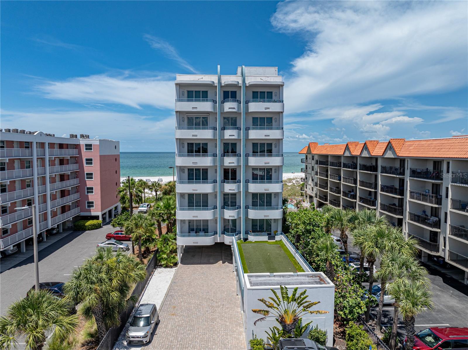 Favorable Owner Financing is Available to facilitate your purchase of this incredible condominium home, right on the sand of beautiful St. Pete Beach! With only 6 units, each of which span the entire floor from east to west, The Dunes on St Pete Beach is like no other. Owned by the Developer, this exquisite condominium home has only had one meticulous owner. Located on the sugary, white sand of St. Pete Beach, the oft-voted #1 beach in the USA and top 5 in the world, the vistas from the 486sf+ western-facing balcony are simply stunning. From this enviable vantage point, the setting sun is a highlight of every day. And yet, as if in competition, incredible sunrises grace the eastern balcony, which boasts another formidable 265sf of covered space with sweeping and vast views across the boulevard and over the water and beyond to the iconic skyline of Downtown St. Petersburg and the Sunshine Skyway Bridge. Indoors the expanse between the balconies is 4,245 acsf of exceptional living space: 3 bedrooms, 3 full baths, 1 half bath, a formal dining room, office, gym area, and media room. The centerpiece is an enormous room that would not be adequately described with the more common term of ‘great room.’ Spectacular Room is more fitting. There you will find a well-appointed open-floor plan, including the kitchen, large pantry, dining area, expansive living room and, of course, a stunning Gulf view which spans almost its full width of 23'. A true “Chef’s kitchen,” this area was painstakingly designed for form and function and features all-wood cabinetry, granite countertops, Sub-Zero and Wolfe appliances, dual sinks providing both a prep area and a cleanse and clear area and more, much more. The primary bedroom encompasses a suite of rooms, including a large bedroom area that also enjoys fabulous views of the Gulf, two walk-in closets with California Closet style built-ins and an enormous primary bath suite that is unique to this building. It has two separate water closets/toilets, a massive shower enjoying natural light, dual sinks and an abundance of cabinetry and granite countertop space. There are two additional guest bedrooms, both en suite. The larger is at the eastern boundary of the condo, as is an office and work-out area. The other guest bedroom was used as an office and features a custom-made bookcase. Unit 400, which is located on the fifth floor, has a single, very convenient under-building parking space. There is also a 1-car garage. This is a rare opportunity to realize your dream of The Beach Life at its finest. Please note that no units at The Dunes experienced any storm damage. And, with a whole-house generator powered by natural gas that services all six units, at The Dunes, you do not have to worry about electricity outages! Built in 2008, all living areas are above base flood and all homes here were high & dry.  Unit 400 had new impact sliders installed beachside in the summer of 2024. (They are not featured in the photos here.) Only two other units have come to the market since their original sale.  As you would expect, the Condominium Association is well-funded and the property is well-maintained. The home may be sold with furnishings. Note that some items are staged, including art & decor, which do not convey.