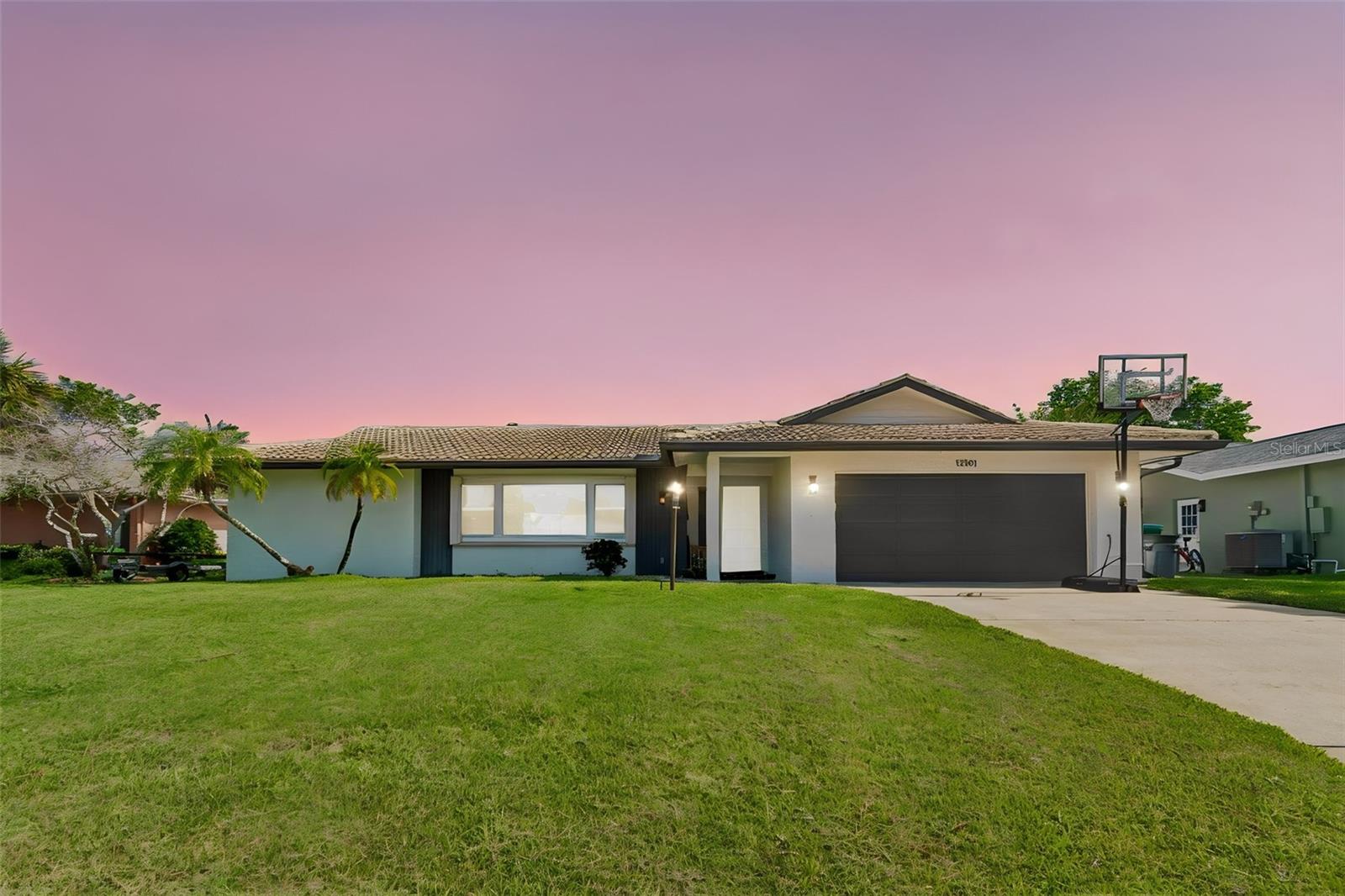 Completely move in ready! Tucked away in a quiet, peaceful Seminole neighborhood, this beautifully updated 4 bedroom, 2 bathroom, 2 car garage POOL home offers just over 1,900 sqft of living space and is perfectly positioned just 1.5 miles from the white sandy shores of Indian Shores and Redington Beach. Located in a non-flood zone with no HOA, this home sits on a 0.19-acre lot and has been lovingly maintained over the years, showcasing fantastic curb appeal with a timeless Mediterranean barrel tile roof. Stepping inside, you'll immediately appreciate the warm character created by the terracotta-inspired porcelain tile flooring and elegant archways throughout the home. A convenient mudroom nook welcomes you in the foyer before leading you into the spacious living room, which flows seamlessly into the dining area and kitchen, creating a functional layout that's perfect for everyday living and entertaining alike. The kitchen is sure to impress with beautiful quartz countertops, ample cabinetry, a center island with additional workspace, a built-in coffee bar, stainless steel appliances, and a stainless steel vent hood that adds a modern touch. A sliding barn door leads into the owner's suite, where you'll find private sliding glass doors opening directly to the pool, a walk-in closet, and an ensuite bathroom. The split bedroom floorplan offers much desired privacy with the  additional bedrooms all generously sized. The guest bathroom features a stylish vessel sink that adds a unique design element. The laundry room provides plenty of additional storage, and the washer and dryer are included for added convenience. Step outside to your own private backyard oasis. A paver patio surrounds the sparkling inground saltwater pool, creating the perfect place to relax or entertain. The backyard offers plenty of privacy, along with ample space for pets to run and play or room to add a playset. Additional upgrades include a whole house water filtration and water conditioning system, a reverse osmosis drinking water system, and hurricane shutters for the windows and doors for peace of mind.  Living in Seminole means enjoying the perfect balance of convenience and the Florida coastal lifestyle. Spend your weekends soaking up the sun at nearby Indian Shores, Redington Beach, or Indian Rocks Beach, explore the scenic walking trails and waterfront views at Walsingham Park and Boca Ciega Millennium Park, or enjoy shopping, dining, and entertainment at Seminole City Center just minutes from home. With easy access to both Downtown St. Petersburg and Clearwater, you'll love having everything you need while still coming home to a peaceful retreat. Schedule your showing today!