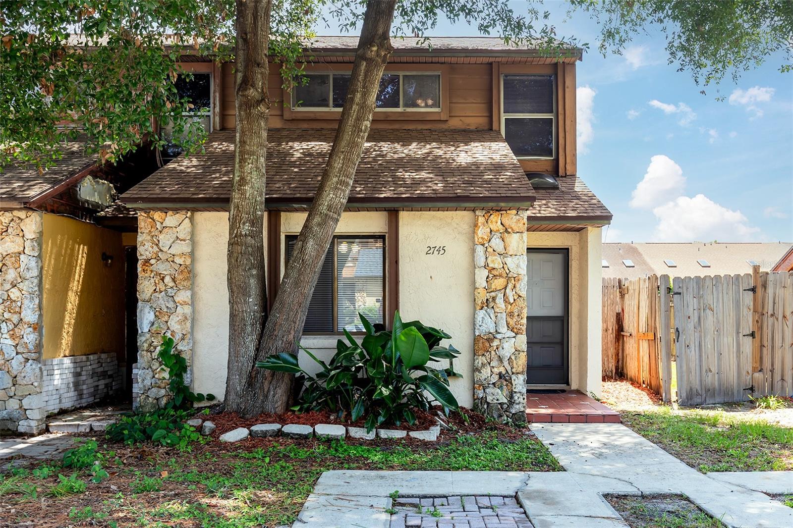 End-Unit townhouse near UCF with no HOA, a private back yard, and all major items recently updated, providing peace of mind for years to come! Whether you are a first-time buyer, seasoned owner, or an investor, this well-maintained, two-bedroom, two-bathroom townhouse sits in one of Orlando's most connected neighborhoods, where recreation, shopping, dining, and education converge. Updates include fresh interior paint and new tile in the downstairs bathroom (June 2026), new range, dishwasher, and washer (2026), new HVAC System (2025), new septic and pump (2023), and a new roof (October 2019). Inside, the vaulted ceiling creates an open, airy feel that anchors the home's layout and frames the main living space, while its covered patio and fenced backyard erase the boundary between indoor and outdoor living, providing the perfect space for all occasions. Privacy is important in this home, with the primary suite and loft upstairs, and the other bedroom and bathroom tucked away on the ground level. This property is an end unit with a nice-sized fenced backyard, providing exceptional privacy. No HOA and ample parking are two other major advantages found here. The location is another major draw, minutes from the University of Central Florida and Full Sail University, and direct access to major roads and SR-408 for smooth commuting. Downey Park, Blanchard Park, and Little Econ Greenway Trail offer immediate outdoor recreation, while Publix Super Market, Waterford Lakes Town Center, and many other plazas are close for convenient shopping, dining, daily needs, and medical services. Schedule your private showing today to experience all that this cozy yet spacious townhouse has to offer.