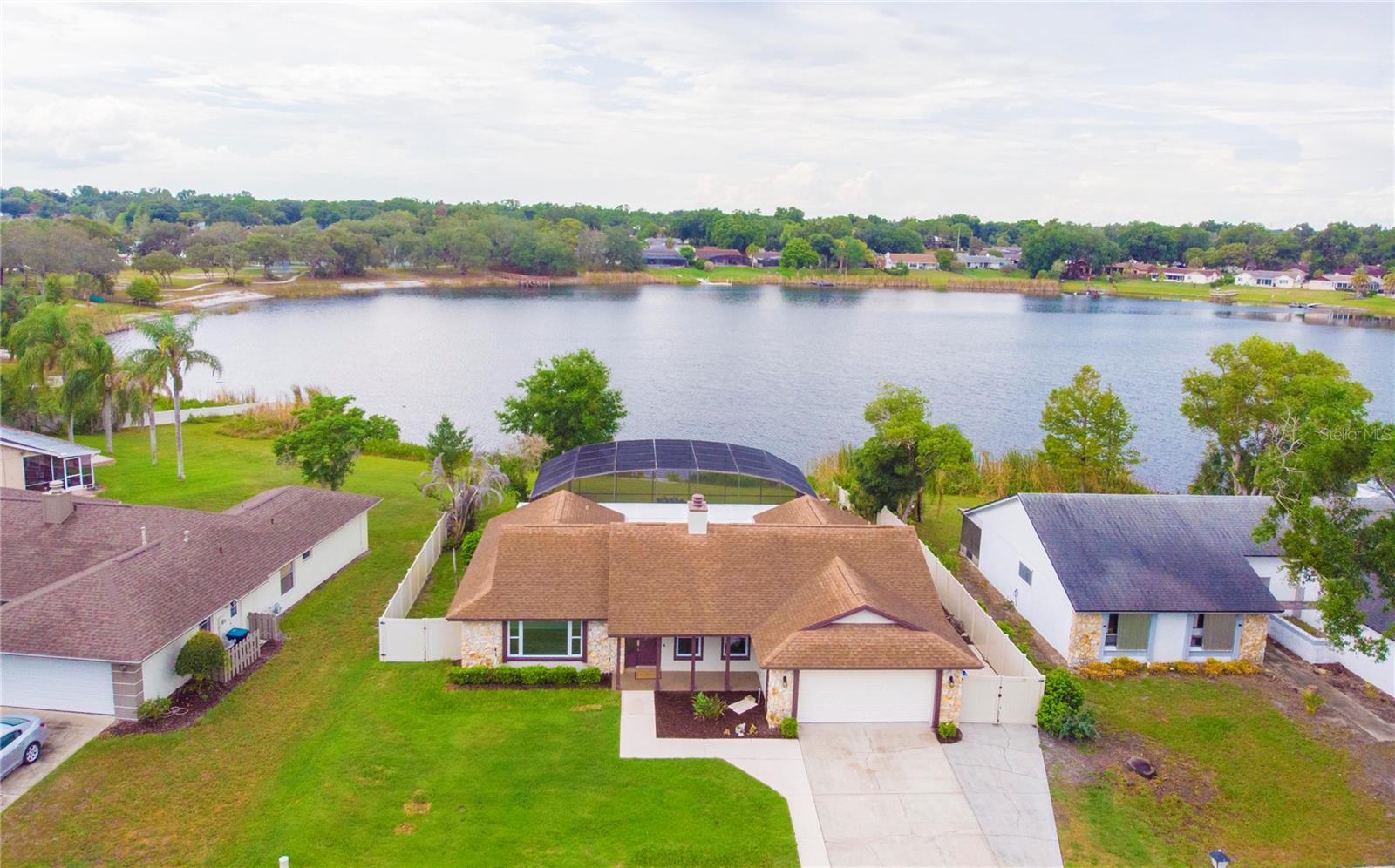 Rare lakefront, pool, & cul-de-sac single family home in the heart of Dr. Phillips in the community of Bay Lakes at Granada. This 3 bedroom 2 bath home with a wood-burning fireplace, bonus office/den sits on a 0.37 acre lot with 84 +/- ft of direct frontage on Lake Tucker. 
This beautiful home features a newly renovated eat in kitchen in 2020 with 42" Bordeaux cabinetry with slow close hinges, quartz counters, tile backsplash, and stainless appliances. The bathrooms were also renovated in 2020 with new vanities and quartz countertops. The primary bath features a zero drop walk in shower along with a multifunction shower panel, in addition the primary bathroom also has a separate makeup vanity/desk. Other updates from 2020 include a full repipe with PEX piping, tankless hot water heater, tile flooring in common areas, and vinyl privacy fence with 2 gates. Other major updates include whole house water softener system, hurricane rated double pane windows (2011), 21.5 Seer variable speed central AC system (2016), architectural shingle roof (2017), LVP flooring in living room and new interior paint (2026). All bedrooms have ceiling fans and the home is well equipped with modern smart switches, thermostat, and touch faucets.
The rear of the home features a sprawling 50'x22' roofed covered porch/patio, 50'x25' screen enclosure, and a 38'x18' deep diving saltwater swimming pool overlooking a large backyard and Lake Tucker. The pool system features a variable speed pool pump and a salt chlorinator generator system.
The community features a 5 acre recreation park with tennis courts, basketball court, pavilion, extensive green space, and 2 fishing docks.
The home is located just minutes away from Bay Hill Club & Lodge, home of the Arnold Palmer Invitational golf tournament, fine dining at Restaurant Row, shopping, the attractions, I-4, and Orlando International Airport. This home is clean and move in ready. Make your appointment to see it today!