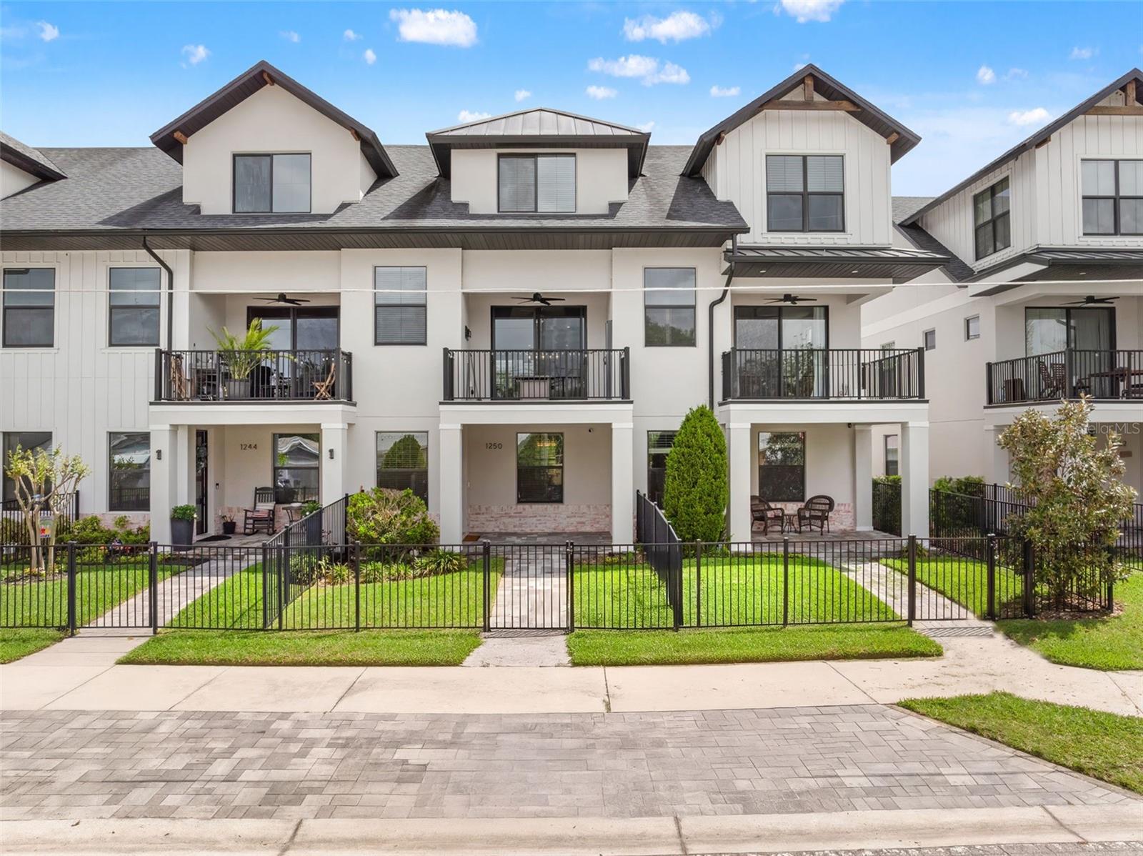 Modern living meets unbeatable location in this stunning 3 bedroom, 3.5 bathroom home nestled in the highly sought-after Urban Green Community. Built in 2022, this move-in ready residence showcases sleek, contemporary finishes throughout all three levels. Step up to a welcoming covered and pavered front porch, fenced-in front yard, and into a thoughtfully designed layout. The first floor offers a private bedroom with its own walk in closet and ensuite—perfect for guests or a home office. On the second floor, enjoy open-concept living with a bright and airy great room featuring high ceilings, recessed lighting, and seamless access to an oversized balcony through sliding glass doors. The modern kitchen is a showstopper, complete with quartz countertops, stainless steel appliances, a walk-in pantry, white shaker cabinets and a large center island with breakfast bar seating. Upstairs, you'll find two additional bedrooms, including the spacious primary suite with a walk-in closet, double vanity, glass-enclosed shower, and built-in shelving. The third bedroom also includes its own ensuite for added privacy and comfort. Additional highlights include an oversized rear-entry 2-car garage, laundry room, ample storage, and low-maintenance living. Enjoy unbeatable proximity to I-4, Downtown Orlando, Dubsdread Golf Course, Rollins College, Park Avenue, and Winter Park Village—offering endless dining, shopping, and entertainment options. This modern gem offers the best of both worlds: a turnkey home in a central, vibrant location. Don’t miss your chance to own in one of Orlando’s most desirable areas!