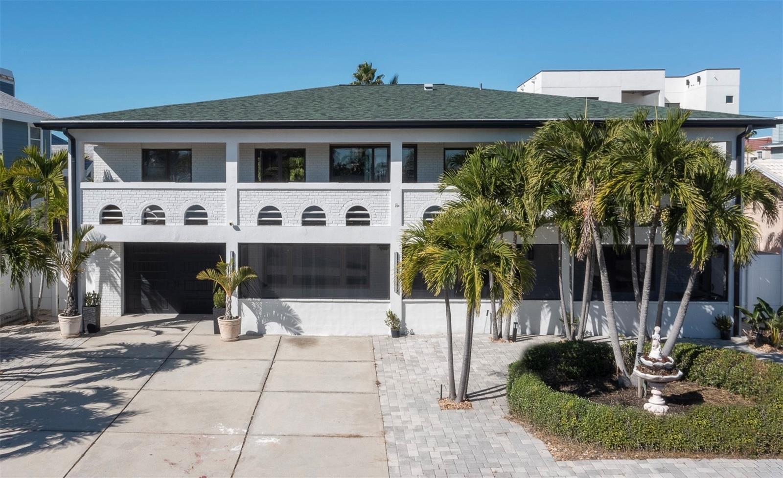 One or more photo(s) has been virtually staged. STUNNING, *ELEVATED* BELLEAIR BEACH HOME ONE BLOCK TO THE BEACH! New roof, windows, & kitchen, bathrooms, & flooring updates -- all in 2023. Now offered at $1,182,000. What if you could embrace a life of coastal elegance, just moments from the Gulf and the white-sand beaches of Belleair Beach’s exclusive, private community? That’s exactly what this exceptional coastal estate delivers. Designed with a perfect balance of sophistication and comfort, this is a peaceful retreat for everyday living that can also effortlessly accommodate gatherings with family and friends. Picture quiet mornings with coffee on the balcony taking in the salt-kissed breeze, followed by evenings filled with laughter as kids and grandkids gather downstairs. The beautifully appointed kitchen serves as the heart of the home, featuring a striking waterfall island, built-in wine fridge, and generous space for lingering over slow weekend breakfasts and meaningful family moments. Throughout, refined finishes elevate the experience—designer tilework, LED mirrors, floating vanities, and sleek fixtures create a cohesive, modern aesthetic. A central vacuum system, separate laundry room, expansive storage, and garage space add ease and practicality to daily life. Two spacious balconies invite seamless indoor-outdoor living, while the versatile ground level offers exceptional flexibility—ideal for a media lounge, hobby or craft room, home gym, or creative studio (within building codes). Step outside to a backyard that feels like your own private retreat. Framed by palms, fruit trees, and a stunning pergola, the space offers the perfect balance of sun and shade—an inviting canvas ready for your dream outdoor oasis. With abundant parking, distinctive architectural character, and endless potential, this Belleair Beach gem is more than a home—it’s a peaceful coastal sanctuary where memories are made and generations gather. All that’s missing is you.