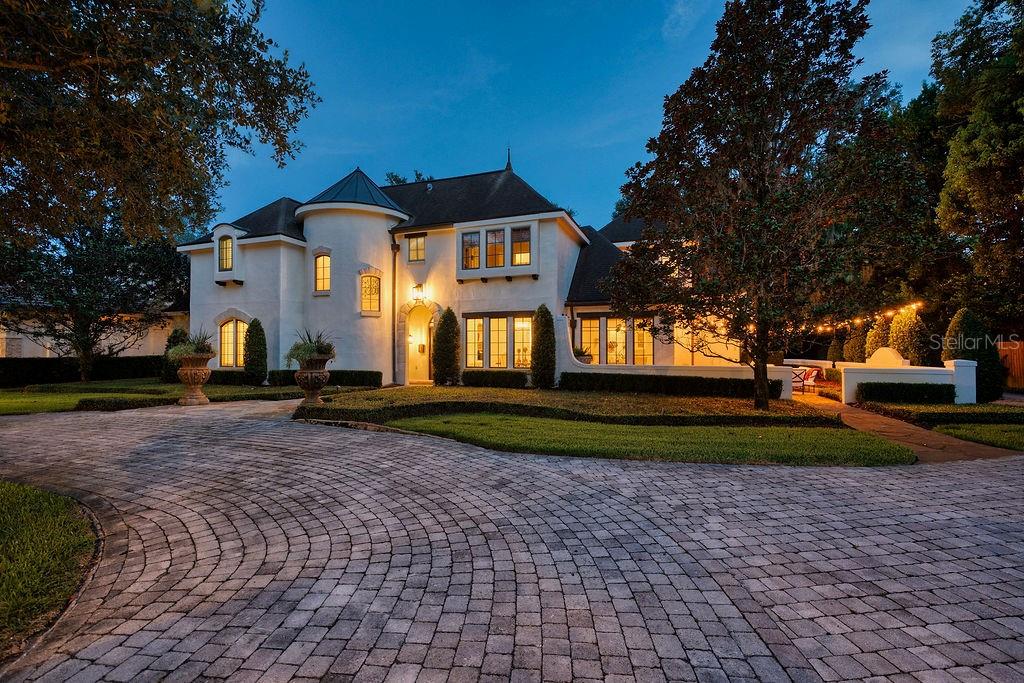 1200 Via Salerno is an elegant and timeless estate home located in the highly sought after Via's neighborhood of beautiful Winter Park, Florida. This exceptional 5 bedroom, 5 ½ bathroom residence is thoughtfully designed by award winning Nasrallah Architecture Group. Whether it's cocktails by the wet bar in the living room, fine dining in the grand dining room, movies in the bonus/media room, or an outdoor pool party, this home seamlessly accommodates all types of gatherings from large crowds to intimate groups. The great room is the perfect blend of comfort and luxury with vaulted ceilings, pecky cypress beams, a wood burning stone fireplace, and custom French doors overlooking the private resort style backyard. The primary suite is intentionally situated in a separate wing on the first floor and boasts a fireplace, dual walk-in cedar closets and a fabulous bathroom. Just off the primary suite is the richly appointed spacious study with Busby cabinetry, floor to ceiling wainscoting, a fireplace, and views of the pool. The quality of design and finishes is maintained on the second floor where there are 4 bedrooms, 3 full bathrooms, a loft, custom built-ins, and lots of closet space. The bonus/media room, accessible from a secondary staircase, includes a wet bar, 2 large closets and an approximately 100 square foot walk-in storage space. Outside there are several areas to enjoy spending time including a patio just off the breakfast room, perfect for morning coffee. The loggia provides plentiful, comfortable outdoor living with a dual sided fireplace, TV and a refrigerator. Additionally, there is a covered porch accessible from every room on the back side of the home. Custom built by Rex-Tibbs, the excellence of the construction is evident through both opulent features like the custom floating staircase and practical items like the whole house generator. Via Salerno is a quiet brick, tree-lined street within close proximity to the restaurants and shops on Park Avenue, Kraft Azalea Gardens, the Winter Park Golf Course, the Racquet Club, and Interlachen Country Club. Room Feature: Linen Closet In Bath (Primary Bedroom).