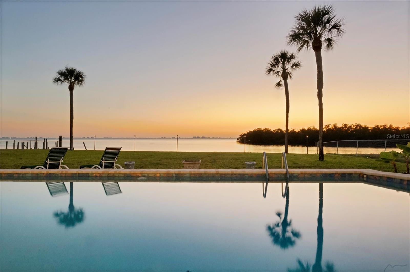 WOW..the view! This exceptional waterfront property is offered for only the second time since 1958. Ideally positioned directly on Sarasota Bay, it features sweeping bay views. Experience the magical sunsets, then the twinkling lights of Longboat Key at night. Nature lovers can enjoy the variety of birds, manatees, and frolicking dolphins. Each day is a new show of natural beauty, and the sunsets never get old. The estate-sized 0.80-acre lot offers approximately 103 feet of direct bay frontage, providing an extraordinary setting for a custom coastal retreat, and a coveted Sarasota address within Manatee County. The existing home sustained hurricane damage, presenting a rare opportunity for a new owner to reimagine or rebuild and create their dream waterfront estate. Located on boating water with access to the Intracoastal Waterway and the Gulf of Mexico, this property is perfectly suited for boating and fishing enthusiasts.  An expansive raised edge pool with paver deck, fenced yard, private well irrigation and propane gas add practical value to this unique offering. The Whitfield Estates community has a rich history and is an eclectic mix of homes from 1920’s Mediterranean architecture to modern designs. Voluntary neighborhood association membership is just $30 annually and includes access to nearby Sara Bay Country Club for culinary membership. Centrally located just minutes from downtown Sarasota’s cultural attractions, dining, shopping, IMG Academy, renowned Gulf beaches, and SRQ International Airport—only five minutes away. Waterfront opportunities of this caliber are increasingly rare. Embrace the potential, the location, and the timeless appeal of Sarasota Bay living, and make this extraordinary property your own.