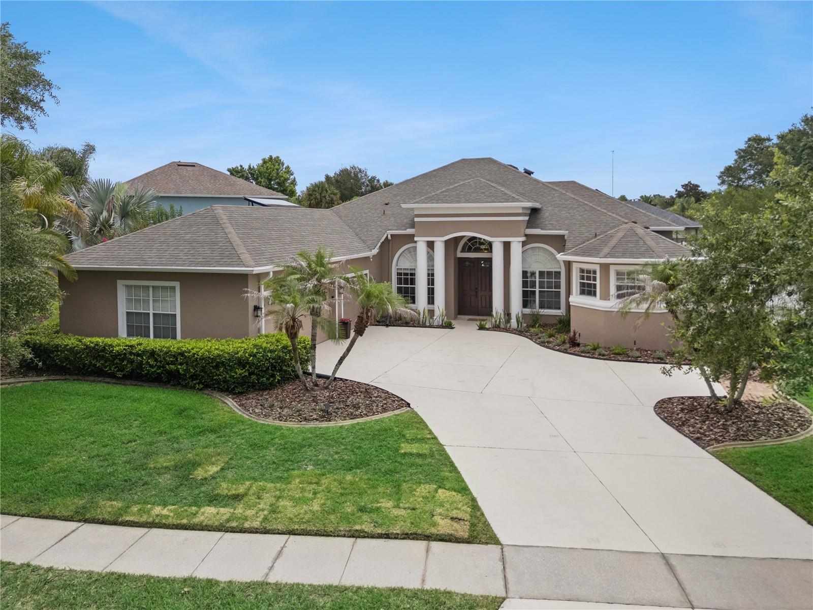 Welcome home to this stunning 4-bedroom POOL HOME with a DEDICATED OFFICE SPACE, perfectly situated on a premium, over 1/3-acre FULLY FENCED LOT in the highly sought-after Cypress Lakes community. From the moment you approach the ELEGANT DOUBLE DOOR ENTRY, you are greeted by an abundance of NATURAL LIGHT, fresh interior paint, and SOARING HIGH CEILINGS that flow seamlessly throughout the main living areas, kitchen, and primary suite. Designed for both formal entertaining and comfortable everyday living, the layout features distinct formal living and dining rooms, complemented by RICH ENGINEERED WOOD FLOORING and GORGEOUS VIEWS of the BACKYARD OASIS from both living areas and the primary retreat. The heart of the home is a chef-friendly kitchen boasting GRANITE countertops, STAINLESS STEEL APPLIANCES, and a GAS STOVE, which opens to a cozy family room complete with a warm GAS FIREPLACE. This highly desirable TRI-SPLIT FLOOR PLAN offers maximum privacy; the LUXURIOUS PRIMARY SUITE sits on the right side of the home, featuring PRIVATE POOL VIEWS, separate closets, both a WALK IN and step in, and a spa-like en suite bathroom with SEPARATE SINK vanities, framed mirrors, a RELAXING GARDEN TUB, and an impressive DOUBLE SIDED WALK IN SHOWER. Off to the left, you will find two spacious guest bedrooms connected by a clever Jack-and-Jill bathroom with a pocket door separating the sink area from the shower/tub combo, while a fourth guest room and a full third bath are privately nestled at the rear of the home. Two guest bedrooms features brand-new, plush carpeting for ultimate comfort. Step outside into your PRIVATE PARADISE through the SCREEN ENCLOSED LANAI to enjoy the SPARKLING POOL with ROOF MOUNTED WARMER, surrounded by a pristine, FULLY FENCED YARD with easy-to-maintain Florida landscaping. A massive 3-car garage provides AMPLE STORAGE, GUTTERS and big-ticket maintenance items are already taken care of with a brand-new A/C installed in 2022 and a new ROOF in 2019. Beyond the home, enjoy incredibly low HOA dues ($210/quarter) that grants you access to resort-style amenities, including a clubhouse, fitness center, billiards lounge, basketball, tennis, pickleball courts, and a community pool with waterslides and lap lanes. Centrally located in the 32820 zip code between downtown Orlando and the space coast beaches, this property offers unbeatable convenience with quick access to the 408 and 417, UCF, Research Parkway, and premier shopping and dining at Waterford Lakes and Oviedo on the Park.