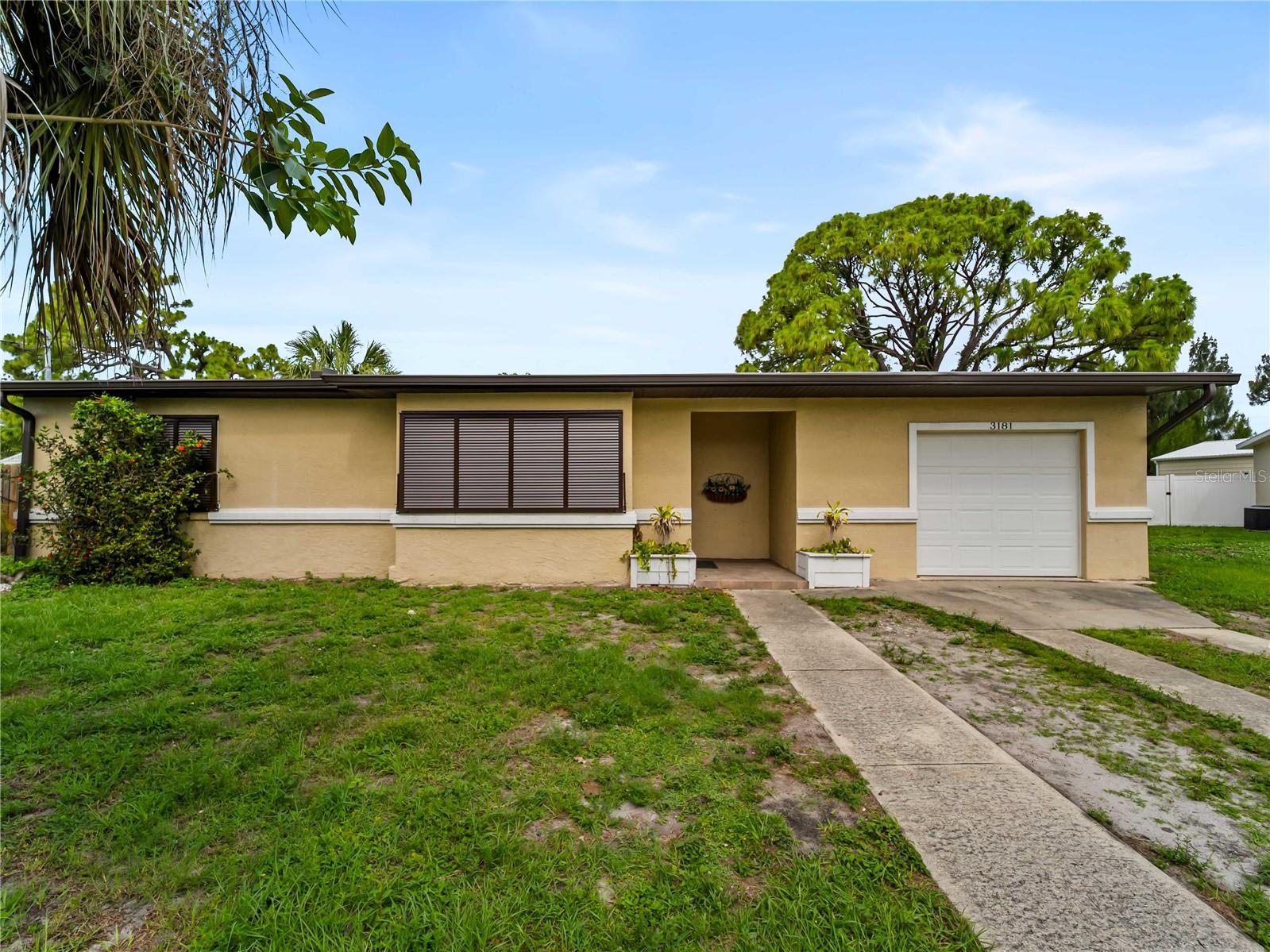 Charming and well-maintained 3-bedroom, 2-bath split floorplan home situated on a peaceful freshwater canal. Having no recent hurricane damage and NO flooding, this home features hurricane impact shutters, a NEW A/C in 2023. Roof replacement in 2020. 
Nature lovers will appreciate the tranquil waterfront setting, where ducks and a variety of birds visit daily. The over-sized lot is filled with fruit-bearing plants and trees, including pineapple, tangelo, lemon, and more. Gather around the firepit on cool evenings and enjoy the privacy and beauty of your own backyard retreat with a fully fenced backyard at 6ft height with two separate run areas—perfect for pets, gardening, or entertaining. Additional features include a spacious garage, a large metal storage shed, and plenty of space for hobbies, recreation, or future improvements. Call today as this is priced to sell quickly.