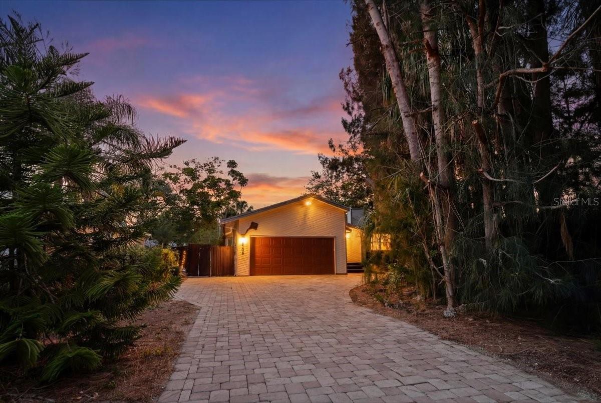 Under contract-accepting backup offers. Welcome to this charming three-bedroom, two-bathroom, two-car garage home that’s located in a quiet area and just minutes from shopping, dining and beaches.
From the moment you step inside, you'll appreciate the rich hardwood pine flooring throughout, soaring vaulted ceilings, and the inviting fireplace that creates the perfect setting for cozy evenings at home. You’ll also enjoy the convenience of the separate laundry room and newer washer and dryer. 
The remodeled open kitchen features an elegant kitchen island that faces the dining area with views towards a large screened-in back porch and the extended screened-in outdoor dining area.
The low-maintenance, fenced backyard features over 1,800 square feet of brick pavers, shaded by sun-sails that are draped between the palm trees, where you can relax to the sounds of nature with your morning coffee or the brilliant painted skyline at sunset.
If you've been searching for a home with personality, warmth, and exceptional outdoor living, this is one you won't want to miss seeing. Priced to sell. Call us for further details or an appointment to take a private tour.