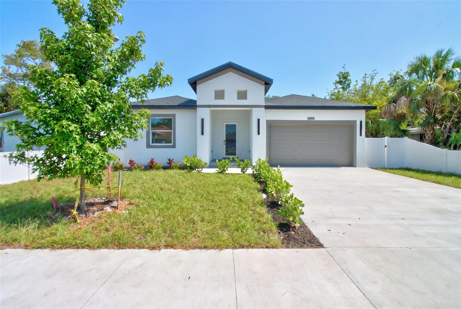 Welcome to this stunning newly constructed residence offering 4 bedrooms, 3 full bathrooms, and 2,220 square feet of thoughtfully designed living space. Upon entering through impressive 8-foot entry doors, you are greeted by soaring 10-foot ceilings, abundant natural light, and an expansive open-concept floor plan designed for both everyday living and entertaining.

The chef-inspired kitchen serves as the centerpiece of the home, featuring an oversized waterfall quartz island, premium quartz countertops and backsplash, custom full size shaker cabinetry, stainless steel appliances, and ample storage space. The seamless flow between the kitchen, dining, and great room creates the perfect setting for family gatherings and entertaining guests.

Luxury vinyl plank flooring extends throughout the home, while the beautifully appointed bathrooms showcase elegant marble-look porcelain tile, designer fixtures, and upscale finishes. The spacious primary suite offers a private retreat complete with a spa-inspired bathroom featuring dual vanities, a walk-in shower, and generous closet space.

Built with quality craftsmanship and attention to detail, this home also features hurricane impact windows and doors, recessed LED lighting throughout, an indoor laundry room, 8-foot premium solid-core interior doors, and 8-foot clearance garage door. Step outside to enjoy the newly installed privacy fence, creating the perfect outdoor space for entertaining, pets, and family gatherings. Built with upgraded foam Insulation, this home is designed for enhanced energy performance, improved climate control, quieter interior, and long-term savings on utility costs.

Conveniently located near shopping, dining, Gulf beaches, Tampa International Airport, and St. Pete-Clearwater Airport. With no HOA, no CDD fees, and located in designated Flood Zone X, this exceptional property offers luxury, comfort, and peace of mind in one beautiful package.