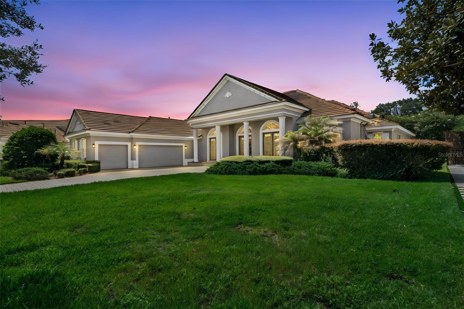 Welcome to The Reserve at Lake Butler Sound, one of Windermere's most prestigious 24-hour guard-gated luxury communities, where estate homes, tree-lined streets, and access to the renowned Butler Chain of Lakes create an unmatched lifestyle. Perfectly positioned on over half an acre at the end of a quiet cul-de-sac, this impeccably maintained 5-bedroom, 3.5-bath residence offers more than 3,750 square feet of thoughtfully designed single-story living with timeless architecture and sophisticated modern finishes.
A paver driveway, mature tropical landscaping, and stately columns create an unforgettable first impression. Inside, grand beveled-glass French doors open to soaring ceilings, elegant architectural details, and expansive sightlines that lead directly to the screened pool and spa  with a beautiful ceramic tiled deck, creating a seamless connection between indoor and outdoor living.

Designed for both everyday comfort and elegant entertaining, the executive open-concept floor plan features formal living and dining spaces accented by tray ceilings, custom lighting, and graceful archways. Rich wood flooring, abundant natural light, and refined finishes elevate every room.

At the heart of the home, the chef's kitchen is as functional as it is beautiful, featuring granite countertops, generous prep space, a large breakfast bar, natural gas counter top and a bright breakfast nook overlooking the outdoor pool and living area. The kitchen flows seamlessly into the spacious family room, where a cozy natural gas fireplace creates the perfect gathering space for family and guests.

Privately tucked away, the owner's suite serves as a luxurious retreat with travertine flooring, dual custom walk-in closets, and a spa-inspired bath complete with dual vanities, an oversized walk-in shower with dual shower heads, and a convenient wet bar. An adjoining flex space offers endless possibilities as a private office, fitness room, reading lounge, or nursery.

The secondary bedrooms are thoughtfully positioned for privacy and functionality, featuring a Jack-and-Jill bathroom, an additional full bath, and spacious accommodations for family or guests. A dedicated office at the front of the home functions as a fifth bedroom, providing exceptional flexibility for today's lifestyle.

Step outside to your private backyard oasis, where the screened pool and spa are surrounded by lush landscaping, ambient lighting, and an expansive covered lanai—perfect for entertaining year-round or enjoying peaceful Florida evenings.

Living in Lake Butler Sound means more than owning an exceptional home—it's embracing one of Central Florida's most coveted luxury lifestyles. Residents enjoy 24-hour guarded security, a private community fishing pier on Lake Butler, beautifully maintained parks and green spaces, and proximity to the Butler Chain of Lakes, one of Florida's most desirable chains for boating, skiing, paddleboarding, and waterfront recreation. The community is also zoned for top-rated schools and is just minutes from downtown Windermere, Restaurant Row, world-class golf, major highways, Orlando's premier attractions, and an exceptional collection of luxury shopping and dining.

This is a rare opportunity to own an elegant estate in one of Windermere's most sought-after luxury communities, where privacy, location, and lifestyle come together in perfect harmony.