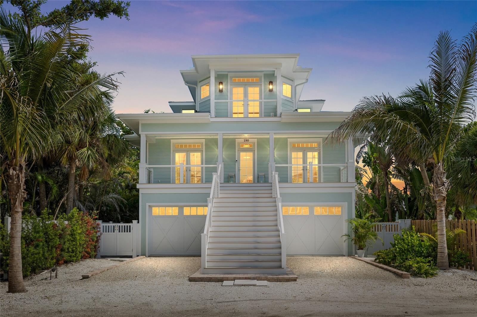 Coastal Luxury Meets Thoughtful Design – Completed in October 2024, this beautifully crafted 4-bedroom, 3.5-bath residence offers a perfect blend of coastal charm and modern luxury. Inside; engineered white oak hardwood & custom tile work throughout, accented with Serena & Lily wall coverings and Pottery Barn window treatments elevating the interiors. An elevator all three levels and two sets of washer/dryers on the two elevated living levels add comfort and convenience. The main living level features two en-suite bedrooms & bathrooms, tasteful dining area including bar cabinets for ease of service off the kitchen & bar dining features off the living room, also overlooking the waterfront! The Master level offers a spectacular en-suite with two large banks of built-in cabinetry with a spacious walk-in closet. Top level back bedroom/den/office/library smartly enhances the Master experience. Ground level 2 car plus golf cart+ garage offers lots of storage, even more air-conditioned storage & excellent bonus space. The bunk room showcases custom-built beds, creating a perfect retreat for the youngsters.

The exterior is built to the highest standards with Hardie board siding, spray foam insulation, hurricane-rated windows and doors, and rebar-reinforced walls—ensuring peace of mind with zero structural impact from recent Storms. Features include tile flooring and Azek batten board detailing, providing both durability and style. The roof system is engineered with high-quality trusses and finished with premium roofing materials for long-lasting protection. Stucco and siding are complemented by custom exterior accessories such as corbels, shutters, and awnings for a refined coastal look. Outdoor living is enhanced with expansive decking, handrails, aluminum screen systems. Additional highlights include a pool and spa with paver surrounds, professional landscaping, and a paved driveway and walkways that complete the enchanting curb appeal.

Outdoor living shines with four covered porches, a main level also screened porch features a full summer kitchen and grill overlooking the pool out to the dock! Master level French doors lead out to another spacious covered deck overlooking the also covered boathouse—with some Harbor view! A large outdoor shower off the sparkling pool by Tropical Pools, out to the private covered dock with two custom 20,000 lb lifts and room for an additional skiff. Multiple storage closets and lockouts provide excellent space for gear and organization.

This home is designed for effortless coastal living with every detail thoughtfully considered. A must-see for a New Construction aficionado!