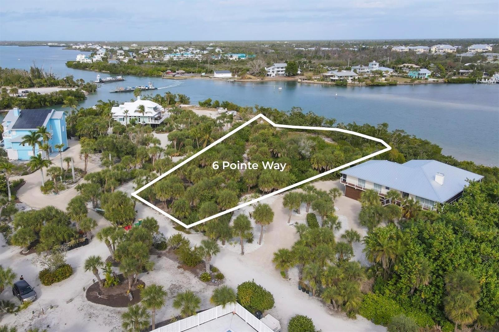 An exceptional opportunity to build your dream home on an oversized, ultra-private waterfront homesite in Pointe Bocilla, one of Don Pedro Island’s most exclusive enclaves. Spanning just over an acre, this remarkable property boasts 242 feet of frontage directly on the Intracoastal Waterway, offering soaring water views, refreshing coastal breezes, and endless boating enjoyment.

The property includes a dock with a new 16,000-lb boat lift, perfectly positioned on a deep canal with quick, direct access to the ICW and the Gulf of Mexico—ideal for avid boaters and anglers alike. Tucked within a quiet HOA of only 12 private homesites, residents enjoy a rare sense of seclusion along with access to a community pool, shaded pool deck, and a charming sitting area where neighbors gather to watch friendly tennis or pickleball matches.

Embrace the relaxed charm of Old Florida living as you settle into true “Island Time,” with nearby access to quiet, pristine beaches known for colorful shells and abundant shark’s teeth. Conveniently accessible via a short car ferry ride with Palm Island Transit, this island retreat offers the perfect balance of privacy, natural beauty, and easy mainland access. A rare waterfront homesite in a setting that feels worlds away—yet close to everything.