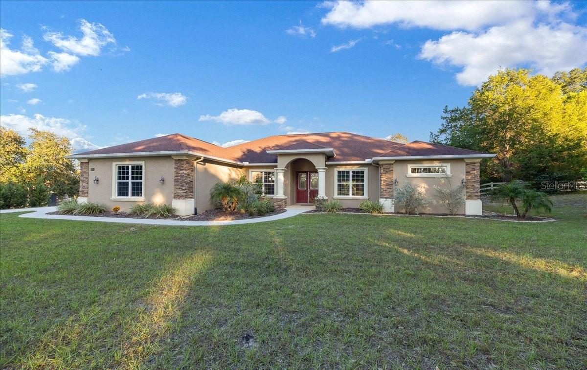 Welcome home to this beautiful 2020-built 3-bedroom, 2-bath home nestled in the desirable Citrus Hills community that combines modern craftsmanship with elegant Florida living. Inside, the open floor plan features a split-bedroom layout, giving everyone their own space while keeping the heart of the home connected. The chef’s kitchen offers a large island, double ovens, tons of storage, and soft close cabinets, great for family meals or weekend entertaining. High tray ceilings with fans add an airy feel, while a flex room or office nook provide space for work or hobbies. The primary suite is a peaceful retreat with dual walk-in closets, a jetted tub, walk-in shower, dual sinks, and a separate water closet—a space designed for comfort and convenience. Step outside to your own backyard oasis with a screened lanai, sparkling in-ground pool with two fountains, outdoor shower, and paver patio, all within a fenced yard. This property offers something for everyone- a real show stopper in person!