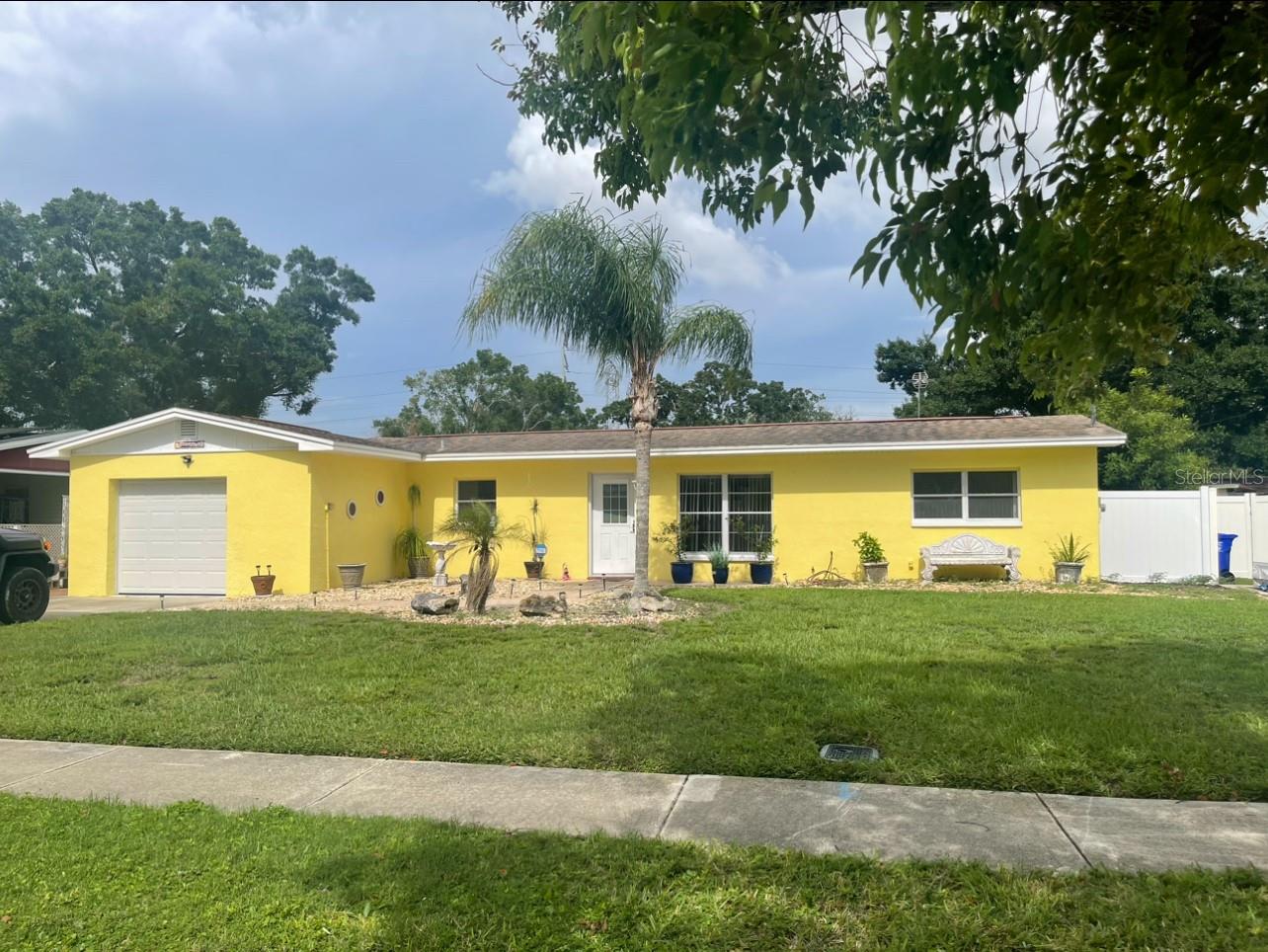 Florida living at it's best. This fully renovated beautiful solid block home is located in the very desirable Oldsmar Country Club Estates neighborhood and is across the street from the bay and just down the street from three waterfront parks, Veterans Memorial Park, R.E. Olds Park and from Mobbly Bayou Beach Park. This charming house boasts a split bedroom open floor plan. It has a giant sun room/all day room connected to the back of the house with plenty of windows surrounding it. The owner is selling personal items to get ready for the sale of the home and they show as clutter in the pictures, so I might be posting new pictures soon. These pictures don't do this wonderful home justice. Wait till you see this huge kitchen with it's quartz countertops, stainless steel appliances and very spacious wood cabinets. There are fruit trees in the back yard which include mango trees and sweet sop trees. The garage is air conditioned and heated. Conveniently located only 15-20 minutes from Tampa International Airport, near parks and access to boat launches, kayaking and paddleboarding, minutes to downtown Tampa and to some of the best beaches in the US, great restaurants, shopping and theaters.