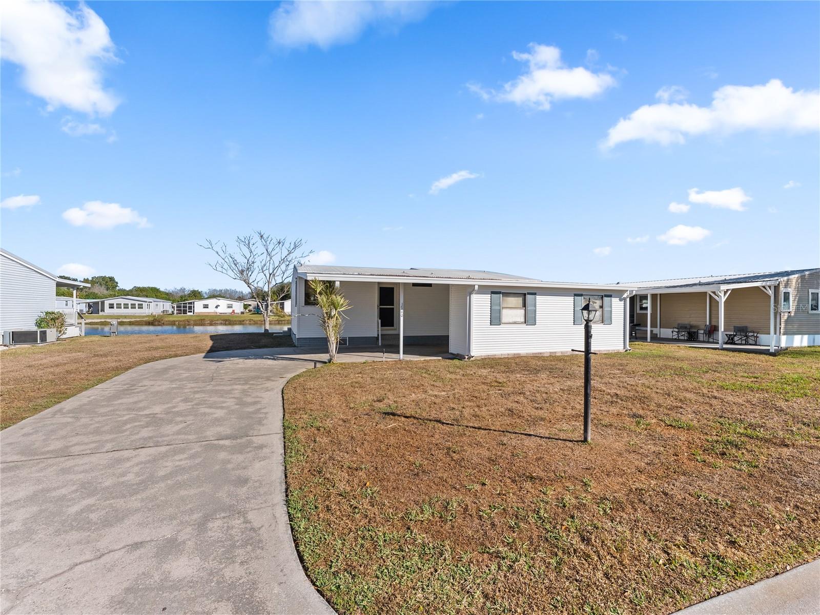 Welcome to Seminole Cove. Mornings here start with water views and coffee. Evenings end with sunsets you'll never get tired of. If that sounds like the pace you're looking for, welcome home. This 2-bedroom, 2-bath home located in a 55+ waterfront community — lives a lot larger than it looks. The layout is open and easy, the 2020 updated kitchen helps make cooking a breeze, and the two enclosed back rooms provide the kind of bonus space you won't expect but never want to give up. Hobby room, home office, art studio — or just a quiet spot to watch the ducks do their thing. Storage is genuinely impressive throughout (have you seen the custom cabinets in the primary bath area?), the seawall runs the full length of the property, and hurricane shutters are included. This home sits in a low flood risk area, so you get all the beauty of waterfront living without the worry. Beyond your door — a pool, clubhouse, shuffleboard, bocce courts, and a walking trail around the pond where mornings slow down in the best possible way. Small boats powered only by a trolling motor are permissible. The home can come furnished. So if you're relocating to Florida, you can skip the moving truck and just start living. Come see it. Some places just feel right the moment you walk in.