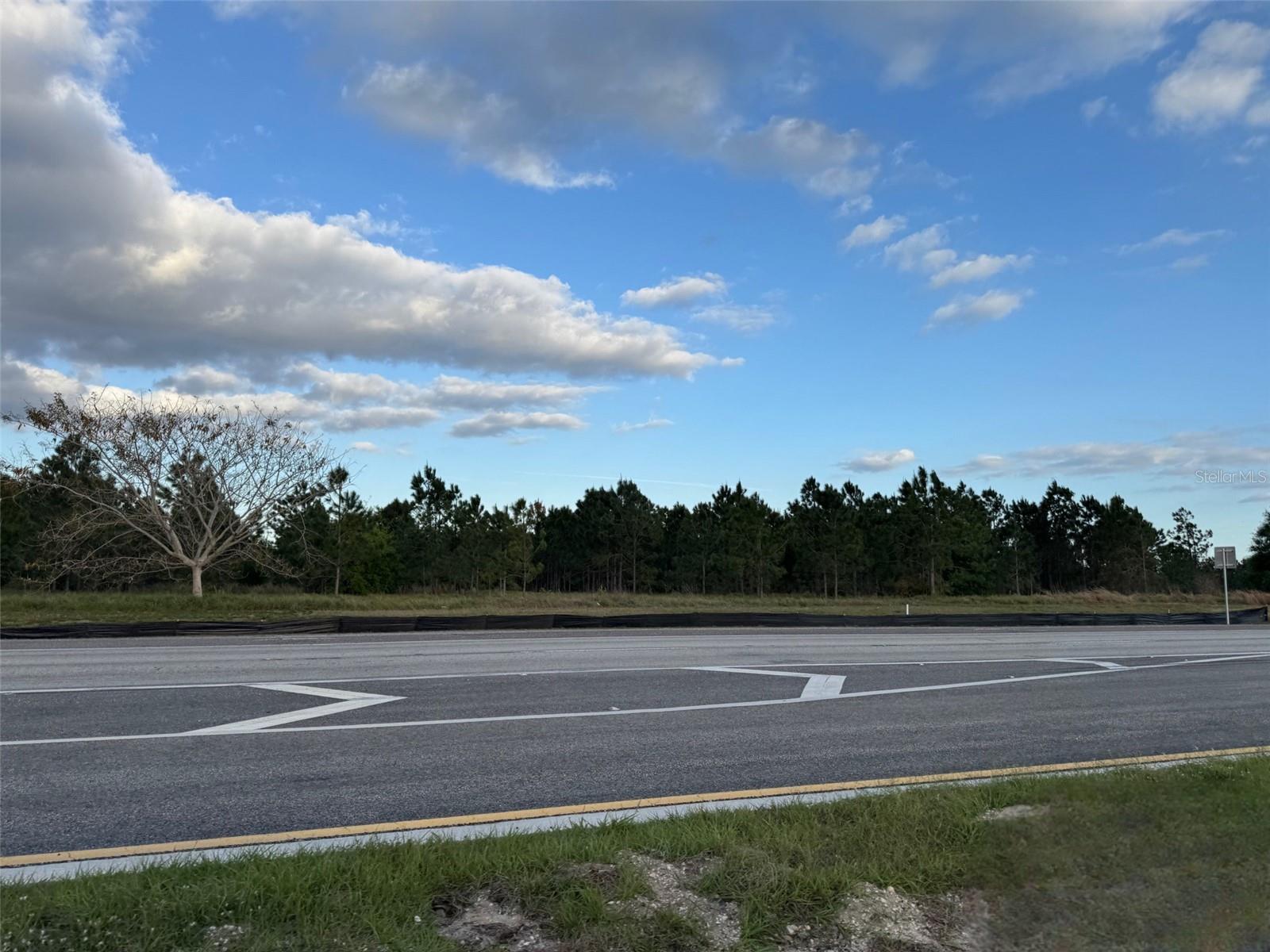 Prime commercial investment opportunity! This 4.5+/- acre parcel boasts an impressive 331 feet of highway frontage in the thriving Town of Lake Placid. Strategically located adjacent to the Race Track gas station and Holiday Inn Express, this high-visibility site is ideal for development. Positioned near Lake Clay, major retailers, and key businesses—including Advent Health Hospital, the Government Center, and public boat ramps—this location offers exceptional accessibility and growth potential. Don't miss this chance to secure a premium commercial property in a rapidly expanding market! Buyer to verify all measurements, zoning, Future land use.