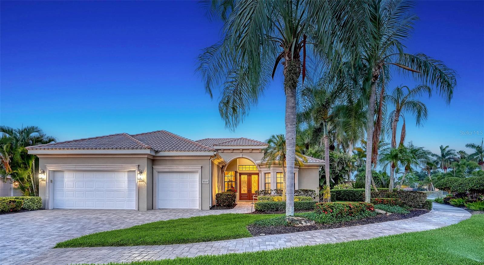 Exquisite custom-built pool home nestled within the prestigious guard-gated community of Silver Oak at Palmer Ranch. Surrounded by lush tropical landscaping, this exceptional residence showcases timeless craftsmanship, welcoming you with a paver driveway, spacious 3-car garage, and impressive wood double-door entry. Impeccable attention to detail is evident throughout, with travertine tile flooring, recessed lighting, crown molding, elegant tray and coffered ceilings, and thoughtfully designed living spaces. Designed with entertaining in mind, the formal dining room flows seamlessly into an oversized sunken wet bar featuring custom wood cabinetry, refrigerator and dishwasher, creating a sophisticated gathering space. Chef’s kitchen showcasing custom rich wood cabinetry, under-cabinet lighting, pullout shelving, granite countertops, stainless steel appliances, center island, breakfast bar seating and a sunny breakfast nook with aquarium window overlooking the pool. The spacious living room embraces Florida living with pocket sliding glass doors that open completely to reveal breathtaking views of the outdoor oasis. Step outside to the expansive screened lanai featuring a Pebble Tec pool, Pentair pool heater for year-round enjoyment, charming mermaid fountain, and a fully equipped outdoor kitchen complete with a Lynx grill, refrigerator, and bar seating. The primary suite serves as a private retreat, offering a tray ceiling, two custom walk-in closets, and a spa-inspired ensuite bath with dual granite vanities, abundant storage, soaking tub, walk-in shower, and private water closet. The desirable split-bedroom floor plan provides privacy for guests with their own wing, dedicated bathroom, and direct access to the pool area. Additional features include a private den with custom built-in desk and wall system, powder bath, laundry room with Samsung front-load washer and dryer (2024), built-in cabinetry and utility sink, security alarm system, central vacuum, and a replaced water heater (2024). Silver Oak is a highly sought-after 24-hour guard-gated community with no CDD fees and maintenance-free lawn care included. Perfectly positioned in Palmer Ranch between Sarasota and Venice, this exceptional location offers easy access to the Legacy Trail, premier shopping and dining, championship golf, entertainment, vibrant downtown districts, and the renowned beaches of Siesta Key and Nokomis.