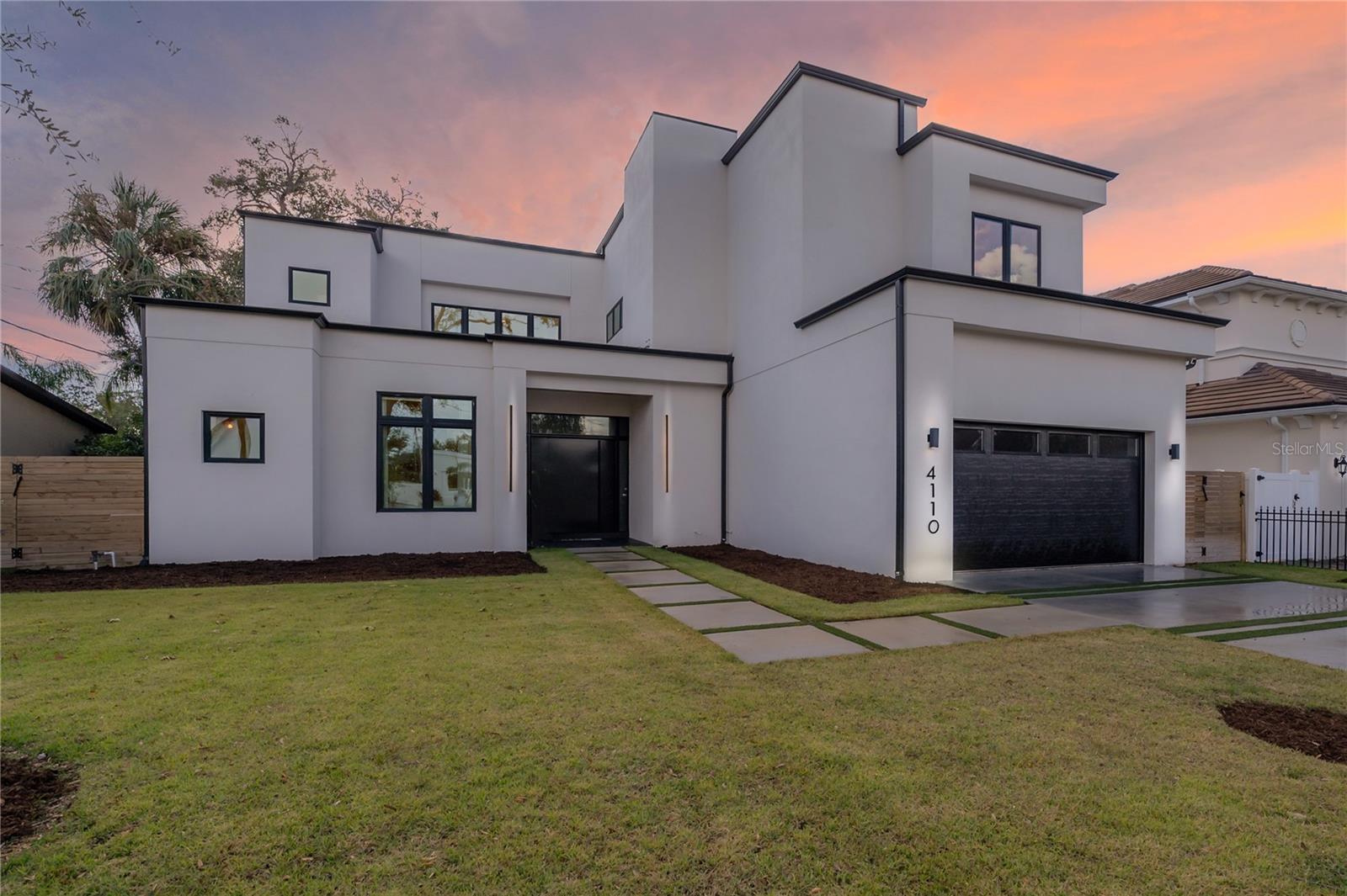 Welcome to your contemporary and inviting luxury residence in Swann Estates, Tampa, FL. This exceptional 2023-built home stands as a resilient modern fortress, having weathered recent hurricanes without any damage or flooding. The elegant property features 5 bedrooms and 6 bathrooms, offering 5,223 square feet of thoughtfully designed living space on a spacious 10,125 square foot homesite. The entry door, reminiscent of a bank vault, sets the tone for the secure and sophisticated lifestyle this home offers.

Step inside to discover the stunning cantilevered glass-clad staircase, a true centerpiece of the home. The open living area features a glass folding NanaWall, seamlessly connecting the interior to the expansive outdoor entertaining spaces. Here, you'll find a long, heated pool with in-pool bar seating, a spa, and a sunshelf/splashpad area, perfect for hosting gatherings or enjoying peaceful relaxation. There's even a sunken seating area where those not swimming can be part of the action at eye level of the swimmers!

The kitchen is equipped with modern conveniences Wolf and Sub-Zero, custom Italian Cabinetry including a sleek drawer microwave, the home is kept comfortable year-round with ultra-efficient air conditioning. The exterior boasts fresh tropical landscaping, xeriscaping, and native grasses, complemented by turf in the back and side yards for easy maintenance.

Safety and resilience are paramount, with all glazed openings being hurricane impact and safety rated, bringing you an insurance discount, safety and noise reduction. The home is equipped with a natural gas whole-home generator, dual tankless water heaters, and dual laundry facilities on the main floor and upper floor for ultimate convenience.

The master bath is a sanctuary of luxury, aspiring to the elegance of an Aveda spa. Complete with backlit mirrors and an option to have natural light come in at the touch of a button to raise the privacy shades.

This residence is not only high and dry, situated outside the required flood insurance zone X. This residence embodies the pinnacle of modern design and functionality. Welcome home to a life of elegance and smart living. Call for a private showing today!