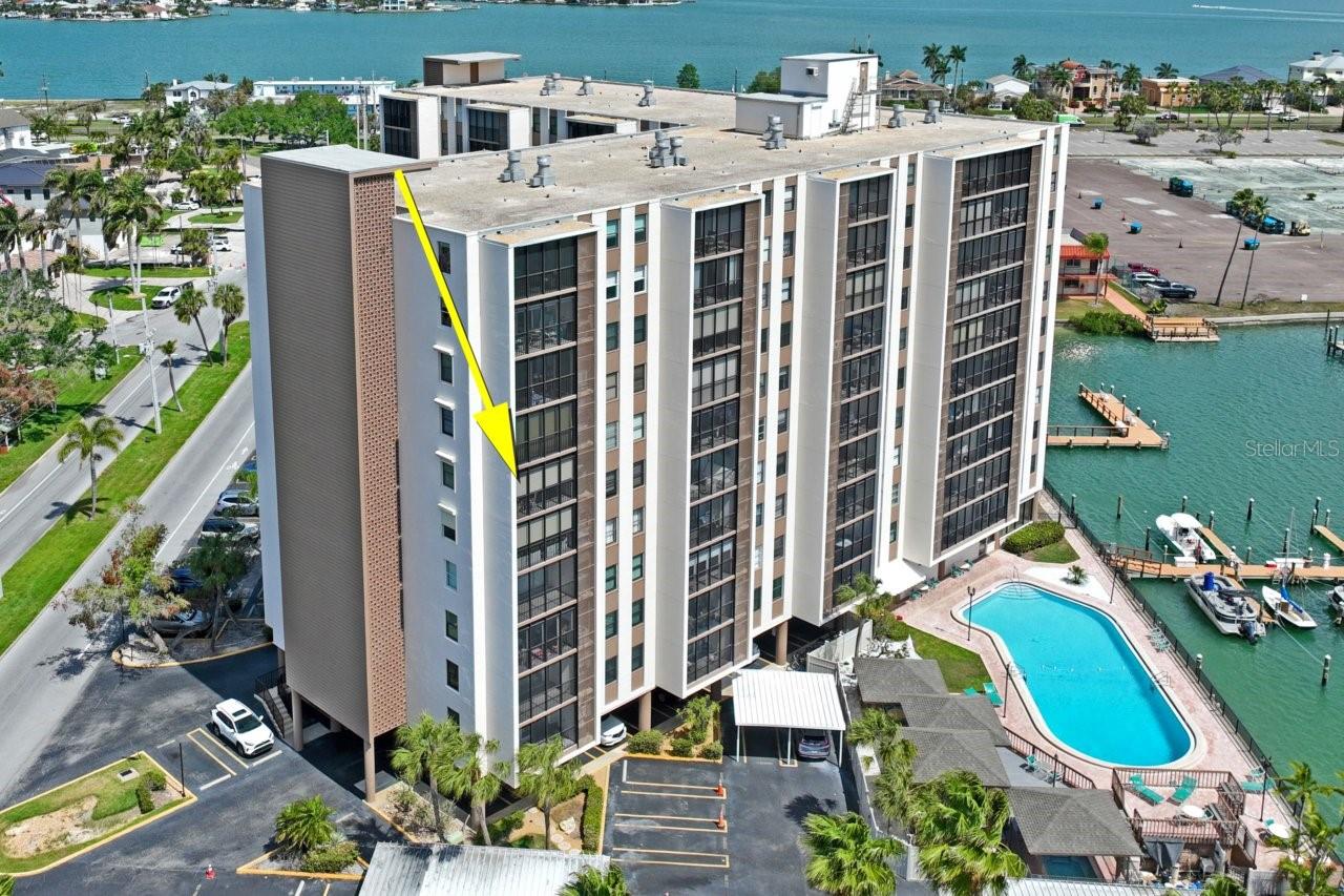 Welcome Home to Paradise Island Tower where you can experience resort style coastal living. This beautifully positioned corner unit 6th floor condo offers the perfect blend of comfort, convenience, and timeless waterfront views. Features two bedrooms, two full bathrooms, a large family room, and spacious dining area.  Step inside to discover a functional layout filled with natural light, designed for both relaxing and entertaining. Enjoy serene views and coastal breezes from your private screened balcony.  Residents of Paradise Island Towers enjoy resort-style amenities including a sparkling waterfront pool, community dock, clubhouse, fitness area, and meticulously maintained grounds. Whether you’re starting your morning with a walk along the water or unwinding poolside at sunset, every day feels like a vacation. Located just minutes from the sugar white sands of Treasure Island Beach, you’ll have easy access to boating, fishing, waterfront dining, and vibrant local attractions. Nearby shopping, grocery stores, cafes, and entertainment options make everyday living both convenient and enjoyable. This is more than a condo, it’s a lifestyle. Perfect as a full-time residence, or seasonal retreat in one of the area’s most desirable communities.  A/C 2023, Electrical 2023, Updated Kitchen and bathrooms.  This condo is priced to sell, so make your appointment today!