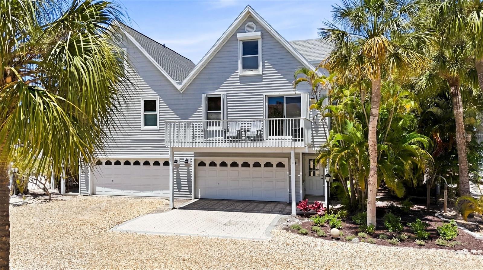 BACK ON THE MARKET! Buyer financing fell through. Priced below market value.  North Beach Village-located in the heart of Holmes Beach on beautiful Anna Maria Island, this property offers the ultimate island lifestyle with beach access directly across the street. Enjoy a leisurely wander to local favorite restaurants, shopping, and island attractions. Enjoy the charm of coastal living in one of the island's most desirable locations. Beautifully furnished and move-in ready, the home features coastal charm and comfort throughout. This three bedroom residence offers a functional and inviting layout ideal for families and guests. The primary bedroom and second bedroom each include queen beds, while the upstairs bedroom is designed for additional guests, featuring a twin over full bunk bed with a twin trundle. The living room sofa also includes a hideaway bed, providing extra sleeping space when needed. Enjoy both front and rear balconies, where open sliding doors invite in the refreshing island breeze and offers a peek-a-boo view of the Gulf. Additional highlights include a new roof (2024), front decking (2023), updated kitchen and bathroom, hurricane shutters for added peace of mind, and a new front door (2026). Unlike a condo, this property is part of an HOA, allowing you to own the land while benefitting from low monthly fees. With weekly rentals permitted, this home presents an excellent opportunity as a high performing investment property, vacation rental, or flexible personal retreat.