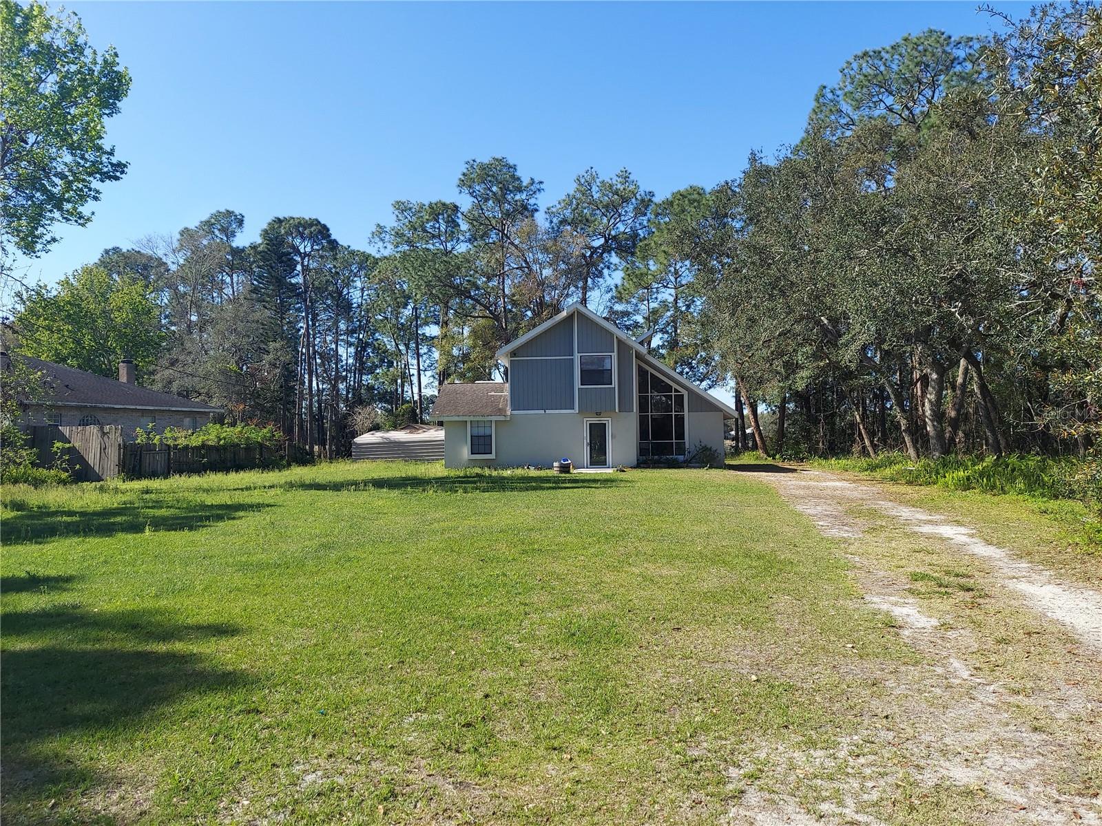 LAKEFRONT LIVING IN DELAND! 

Welcome to 2449 E Lake Drive, DeLand, Florida – a beautifully updated 3-bedroom, 2-bath lakefront home offering the perfect blend of comfort, recreation, and convenience. Situated on nearly half an acre with approximately 75 feet of waterfront frontage, this property is ideal for those seeking a peaceful Florida lifestyle.

Recent improvements include a new roof, new windows, updated doors, modern fixtures, and a remodeled kitchen featuring granite countertops and stainless-steel appliances. The open living spaces showcase vaulted ceilings and abundant natural light, while the second-story balcony provides breathtaking lake views and stunning sunset scenery.

Step outside to enjoy fishing, boating, paddleboarding, or simply relaxing by the water from your private dock. Conveniently located near I-4 and US-92, this home offers easy access to Daytona Beach, Orlando attractions, shopping, dining, and Historic Downtown DeLand.

Whether you're looking for a primary residence, vacation getaway, or investment opportunity, this lakefront gem delivers exceptional value and lifestyle.

Schedule your private showing today and experience waterfront living at its finest!
Owner is willing to lease option or rent to own with credit approval.