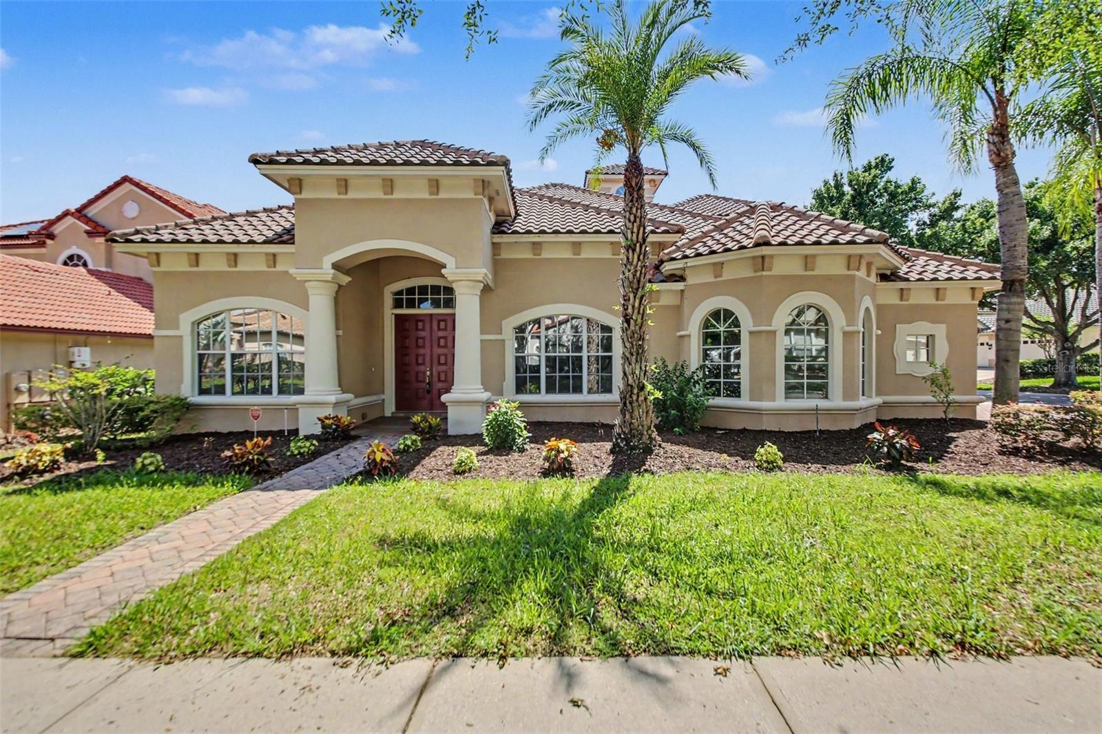 Welcome to this stunning luxury pool home in the prestigious 24-hour guard-gated community of Vizcaya, an award-winning neighborhood in the heart of Dr. Phillips. Ideally located within walking distance of Orlando's renowned Restaurant Row and just minutes from world-class attractions, shopping, and major highways, this exceptional location offers the perfect blend of convenience and luxury.

Situated on a desirable corner lot, this spacious residence features over 3,700 square feet of living space with 5 bedrooms, 4 full bathrooms, and a versatile floor plan ideal for a growing family, multi-generational living, or creating the perfect home theater, game room, or office.

The gourmet kitchen is designed to impress with granite countertops, a large center island, premium stainless steel appliances, and an oversized walk-in pantry. A separate laundry room provides additional convenience with washer and dryer hookups.

The luxurious primary suite is a private retreat featuring a beautiful bay window, spacious walk-in closets, dual vanities, a separate walk-in shower, and a relaxing Jacuzzi tub. Upstairs, a second primary suite with its own full bathroom and walk-in closet offers excellent flexibility for guests or extended family.

Step outside to enjoy Florida living at its finest with a large covered lanai, private swimming pool, and an oversized three-car garage. Residents of Vizcaya enjoy resort-style amenities, including tennis courts, a clubhouse, fitness center, and playground.

This exceptional Dr. Phillips home offers the space, elegance, and location that today's buyers are looking for. Schedule your private showing today.