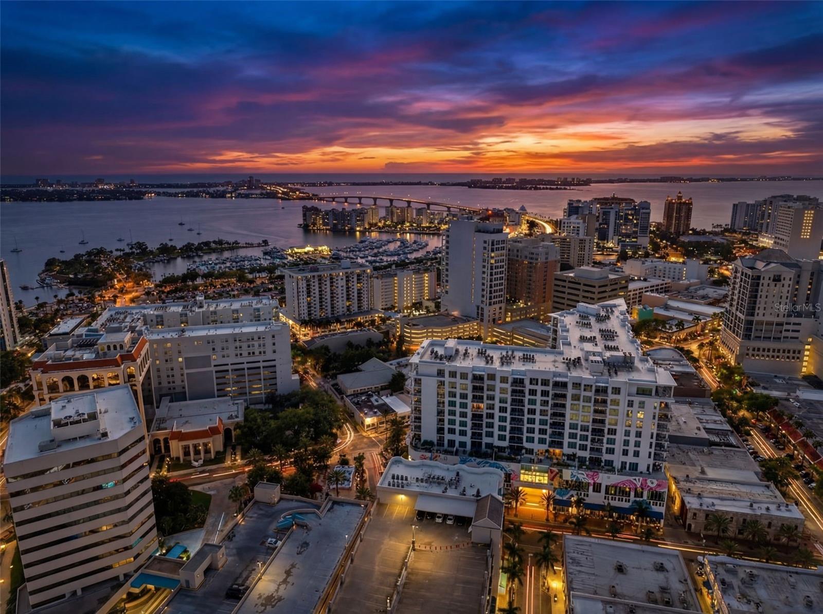 Experience elevated downtown living at The Mark, Sarasota’s premier luxury address. This exceptional 8th-floor corner residence offers 2 bedrooms plus a den, 2.5 baths, abundant natural light, and rare dual private terraces—the only floor plan in the building featuring both a spacious main terrace and a separate terrace off the primary suite. Desirable south-facing exposure captures beautiful sunrises, partial sunset views, and partial Sarasota Bay views while providing exceptional privacy. Interior highlights include porcelain tile flooring, remote-controlled shades throughout, custom built-ins, and a designer kitchen with striking two-tone European cabinetry, full-height backsplash, and premium appliances. Located in the heart of downtown Sarasota, enjoy a true walkable lifestyle with Main Street’s acclaimed dining, shopping, galleries, theaters, and waterfront attractions just steps from your door.