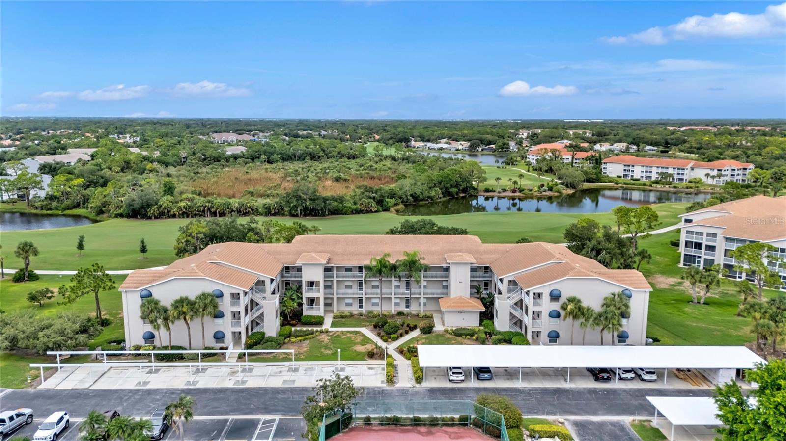 Enjoy effortless Florida living from this beautifully furnished, THOUGHTFULLY UPDATED FIRST-FLOOR residence overlooking the THIRD FAIRWAY in the highly sought-after gated community of Stoneybrook Golf & Country Club. Offered FURNISHED (excluding staging décor), this exceptional home offers elegant updates and maintenance-free living. Thoughtfully updated, the unique open-concept floor plan creates a bright and inviting atmosphere that's ideal for both everyday living and entertaining. Stunning LUXURY VINYL PLANK FLOORING flows throughout the home, while the beautifully modernized kitchen serves as the centerpiece of the living space. Elegant granite countertops, soft-close cabinetry, and a stunning oversized one-level granite peninsula create a sophisticated focal point. Designed as a natural extension of the kitchen, the peninsula comfortably functions as the dining table, creating a clean, contemporary layout ideal for entertaining and everyday dining. The private screened lanai overlooks the beautifully manicured THIRD FAIRWAY and lush preserve, creating the perfect setting for morning coffee or relaxing at day's end. Whether you're entertaining friends or simply enjoying a quiet evening at home, the seamless flow between the kitchen, living area, and lanai creates an inviting indoor-outdoor living experience that truly embodies the Florida lifestyle. The spacious primary suite offers a walk-in closet and a beautifully updated en-suite bath featuring modern tile, a granite vanity, and a stylish barn door for added privacy. A unique swivel-mounted television can be enjoyed from both the bedroom and the lanai, creating the perfect place to relax after a day on the course. The guest bedroom and beautifully updated guest bath provide comfortable accommodations for family and visitors. This home is being offered beautifully FURNISHED (excluding staging décor), allowing you to move right in and immediately begin enjoying the Florida lifestyle. Enjoy the convenience of FIRST-FLOOR LIVING with no stairs to climb, ASSIGNED COVERED PARKING, a PRIVATE EXTERIOR STORAGE UNIT, and new HURRICANE-RATED CARPORTS AND STORAGE ROOMS scheduled for completion this summer, making full-time residence or seasonal ownership effortless. Ownership in Stoneybrook Golf & Country Club includes access to one of Sarasota's premier member-owned country club communities featuring a recently redesigned Arthur Hills-designed CHAMPIONSHIP GOLF COURSE, driving range, chipping area, putting green, full-service clubhouse and restaurant, Har-Tru tennis courts, fitness center, heated pool and spa, bocce courts, walking and biking trails, and an active social calendar filled with year-round activities. The condominium amenities further include an outdoor pool, grilling area, tennis and pickleball courts. Ideally located in the heart of PALMER RANCH, you'll enjoy convenient access to the Legacy Trail, Siesta Key Beach, Downtown Sarasota, Venice and Nokomis beaches, renowned theatre and arts, world-class dining, shopping, healthcare, and everything Florida's spectacular Gulf Coast has to offer. More than just a condominium, this is an opportunity to embrace a true Florida resort lifestyle—where championship golf, tennis, pickleball, fitness, dining, and beautiful natural surroundings become part of your everyday life. Whether you're searching for a full-time residence or the perfect seasonal retreat, this exceptional home is ready to welcome you.