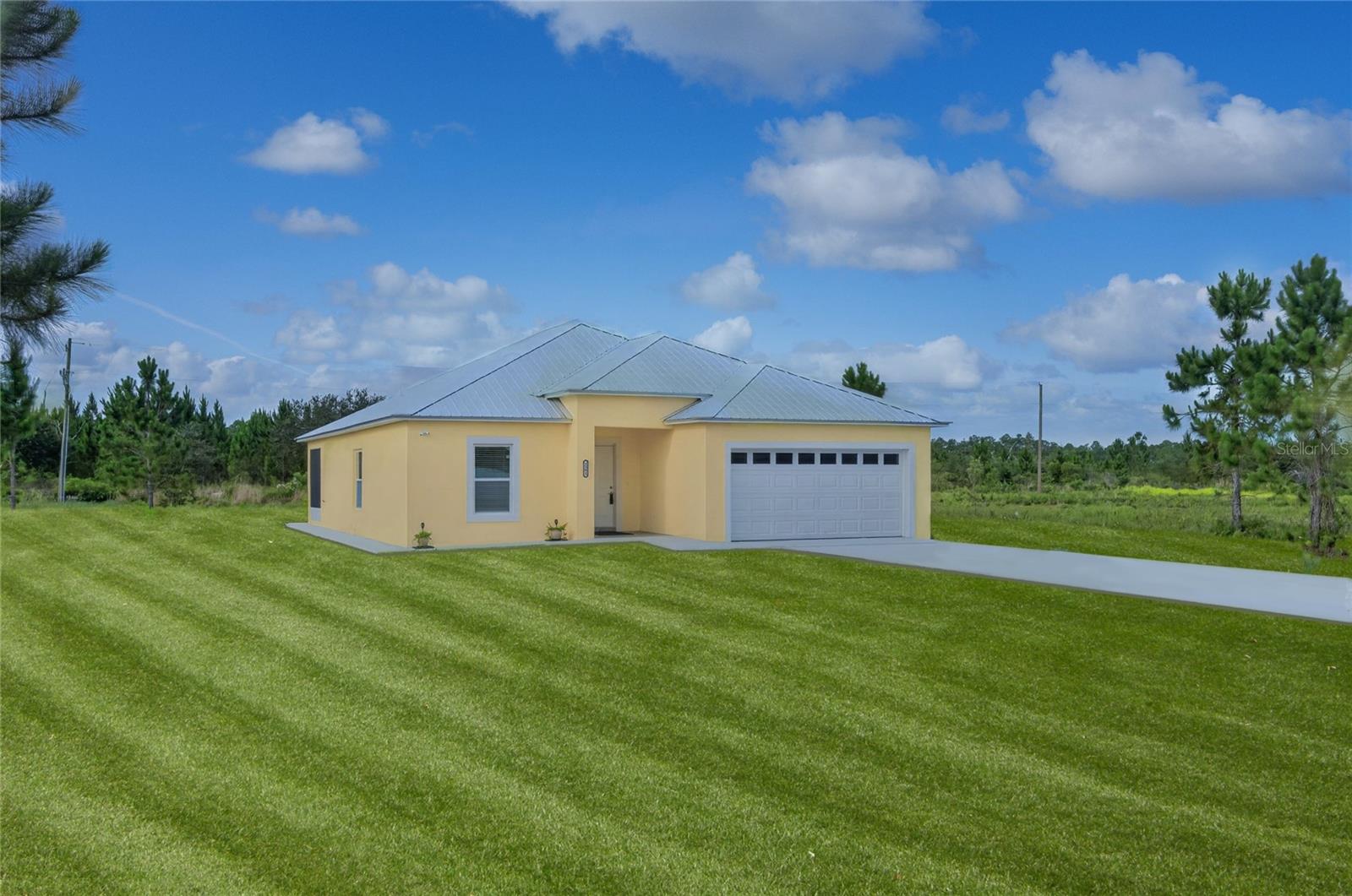Under Construction. LET'S GET YOUR FAMILY MOVED IN BEFORE SCHOOL STARTS! This new home should “tick a lot of boxes” for most people. Are you looking for new construction? Check! Three bedrooms? Check! Two bathrooms?  Check! Open Kitchen Dining Living space?  Check! Indoor laundry? Check! Back screened porch with ceiling fan? Check! Outside of town, but not too far for grocery delivery? Check! Plenty of room for the kids to run and play outside? Check! Nearby neighbors, but not too many? Check! Restaurants in the neighborhood when you don’t feel like cooking or want take-out? Check! Private roads so you can drive your golf cart to the clubhouse to golf or to the pier to watch the sunset? Check! PLUS, a refrigerator, stove, dishwasher, microwave, AND washer and dryer are included. PLUS, the house perimeter has been cemented to protect your foundation and allow for easy walk around. PLUS, the back porch and garage floor have been professionally epoxied to eliminate dirt and dust when you walk in the door. Indian Lake Estates (informally, ILE) was designed to be close to everything in Florida, but with large, oversized, ½-acre lots for privacy. One hour to the ocean in Vero Beach, and just under 90 minutes to the Gulf in Clearwater. Orlando and Tampa are easy drives for concerts, shopping and access to cruise lines. Miami is a few hours away with easy access to Highway 27, the Florida Turnpike, and Interstate 95. The golf course was designed by Gary Cobb, who went on to design for the PGA. The clubhouse restaurant is open 7 days a week, complete with a game room, multipurpose room, ballroom and patio view of the putting green and golf course. The roads are private, so take your golf cart a couple miles down the road to the neighborhood bakery for an ice cream, or to watch the sunset over the largest lake in Polk County, Lake Weohyakapka. The active community offers concerts, karaoke and trivia nights, weekly card games, bingo, movie nights, a book club, pickleball and tennis courts, just to name a few. Indian Lake Estates is a perfect balance of privacy and activity. This home is perfect for a second Florida getaway home, a traditional family home, or an investment. Call your agent today to see this immaculate home and be the first to own it! ILE IS THE PLACE TO BE!